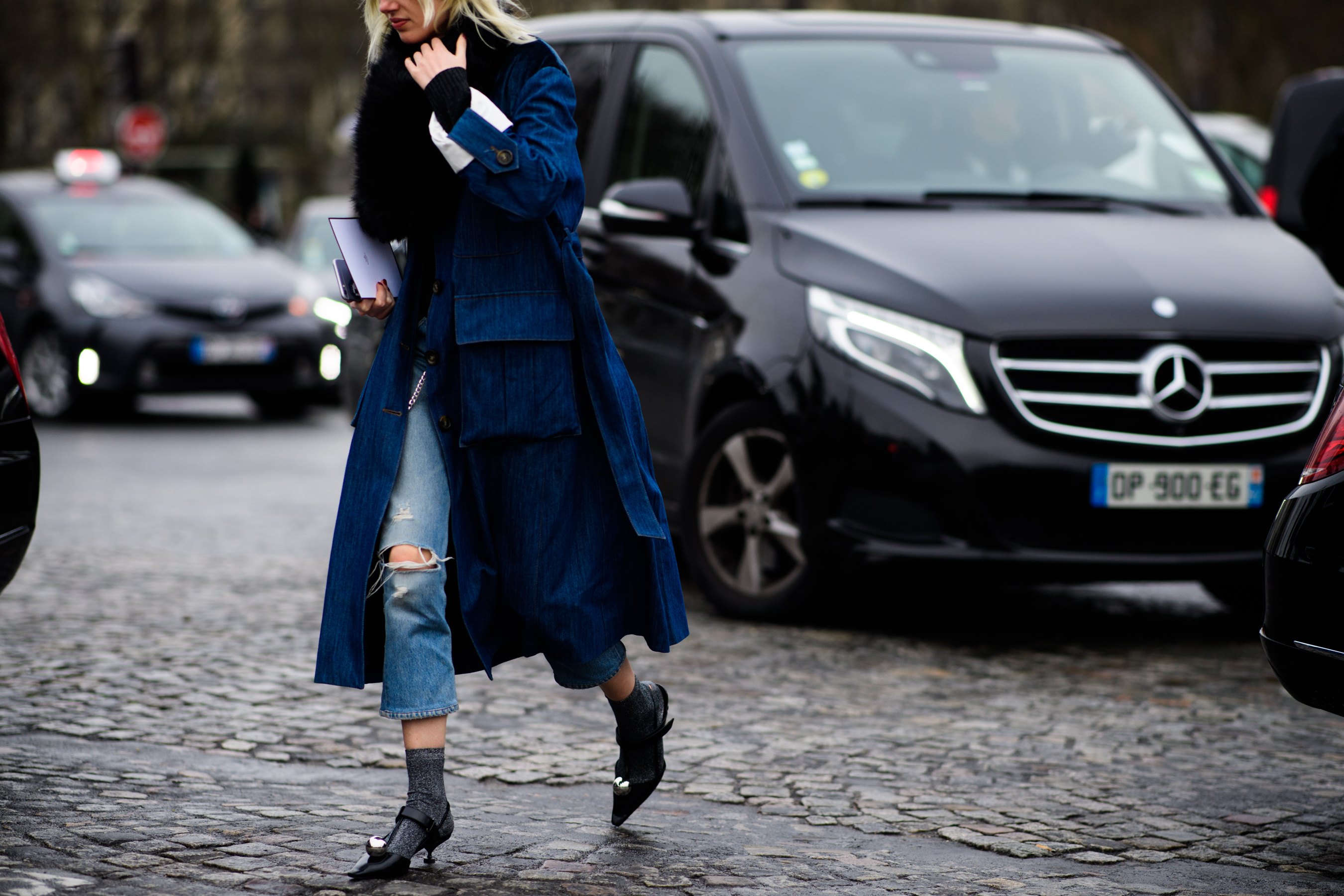 Woman wearing long denim coat