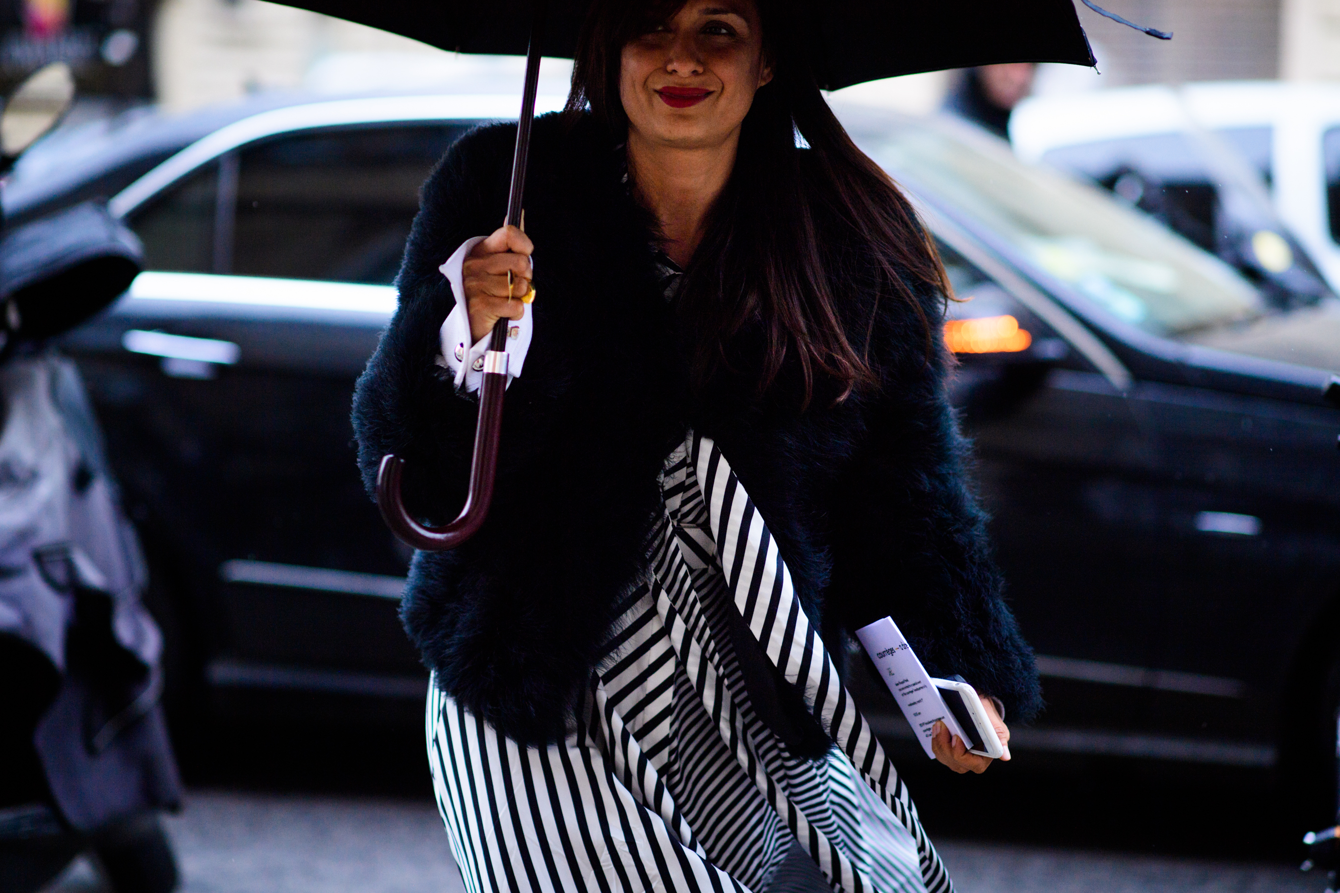 Woman wearing black coat and dress