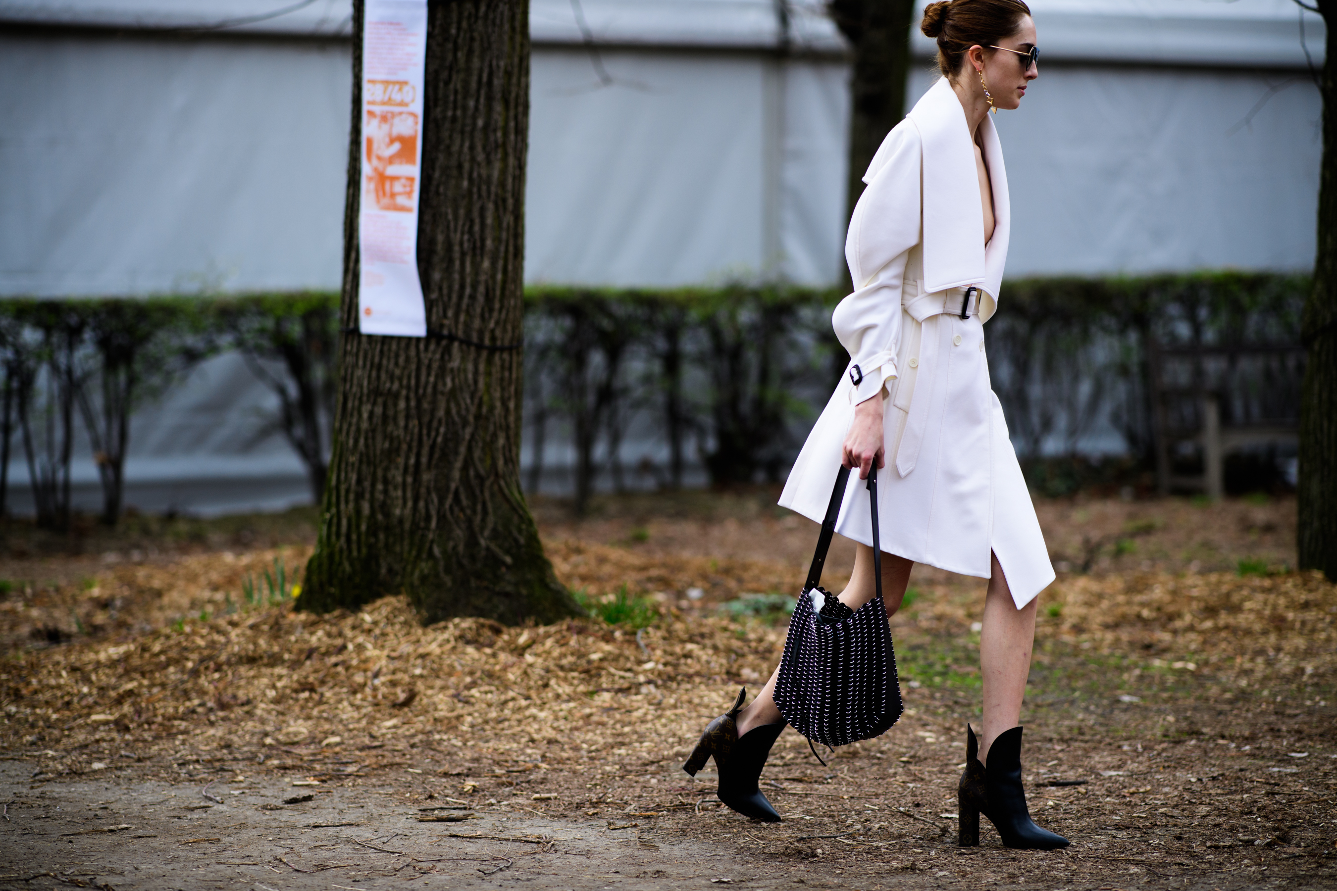 American model wearing white coat