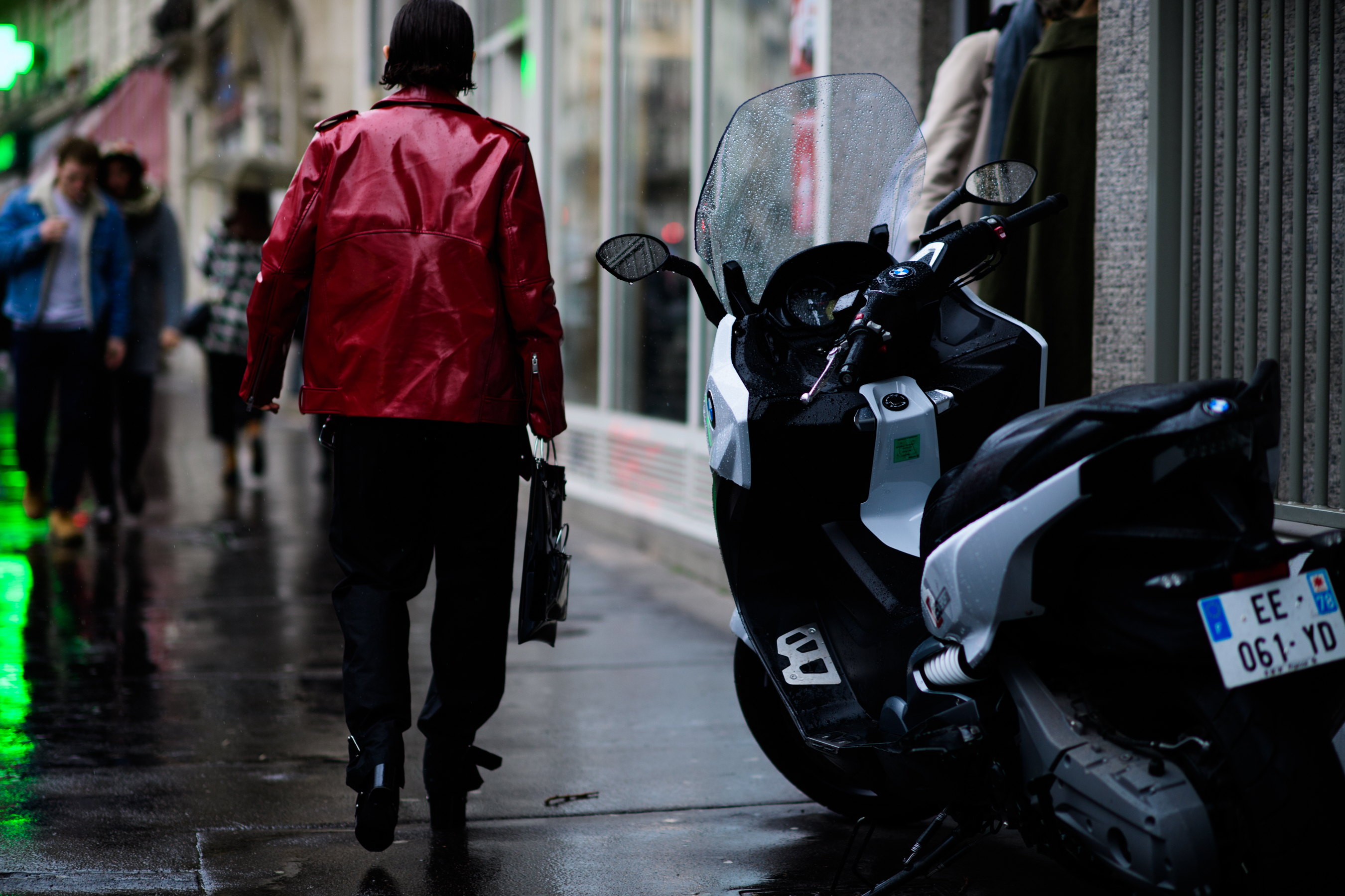 Woman wearing red shiny leather coat