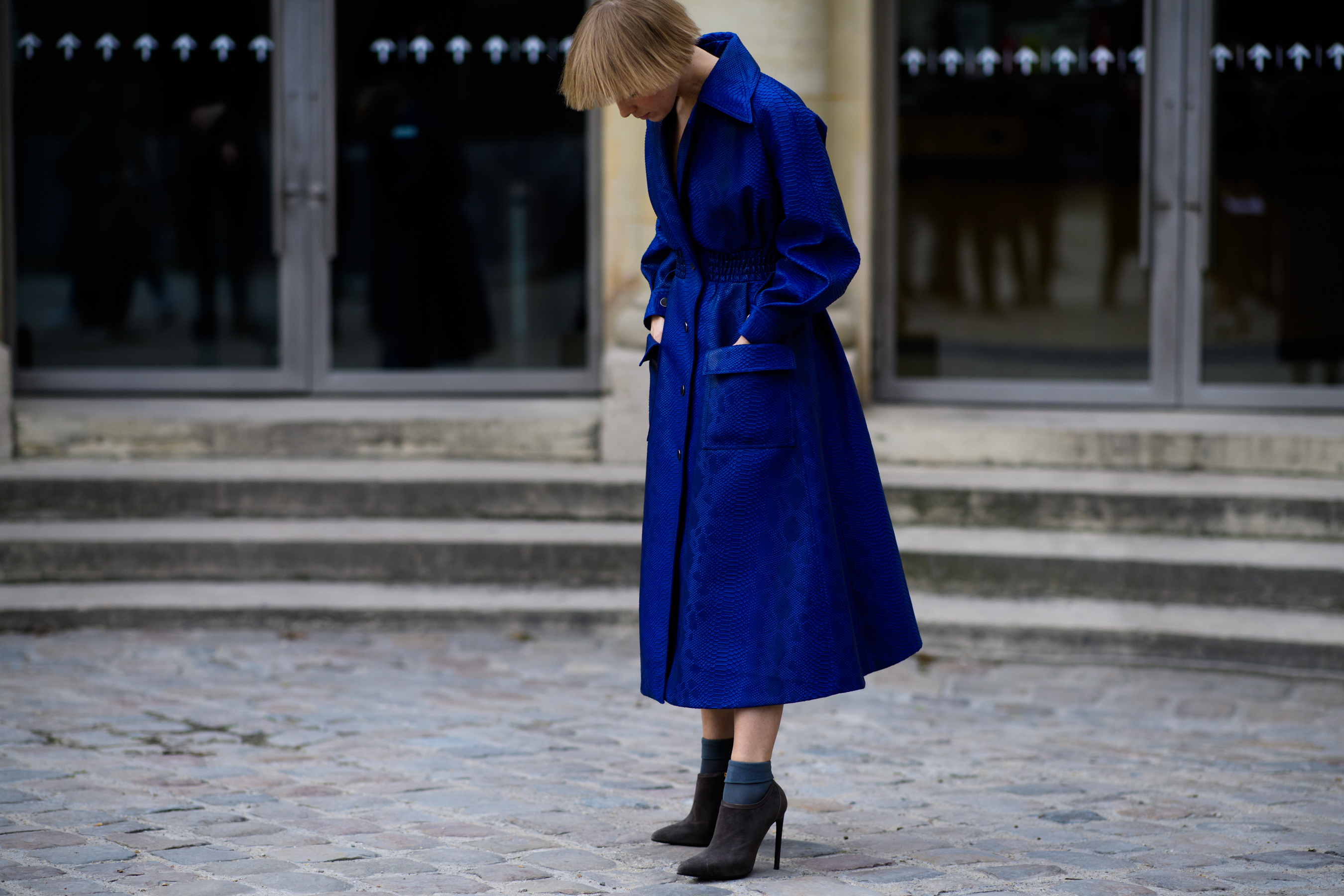 Russian designer wearing blue coat