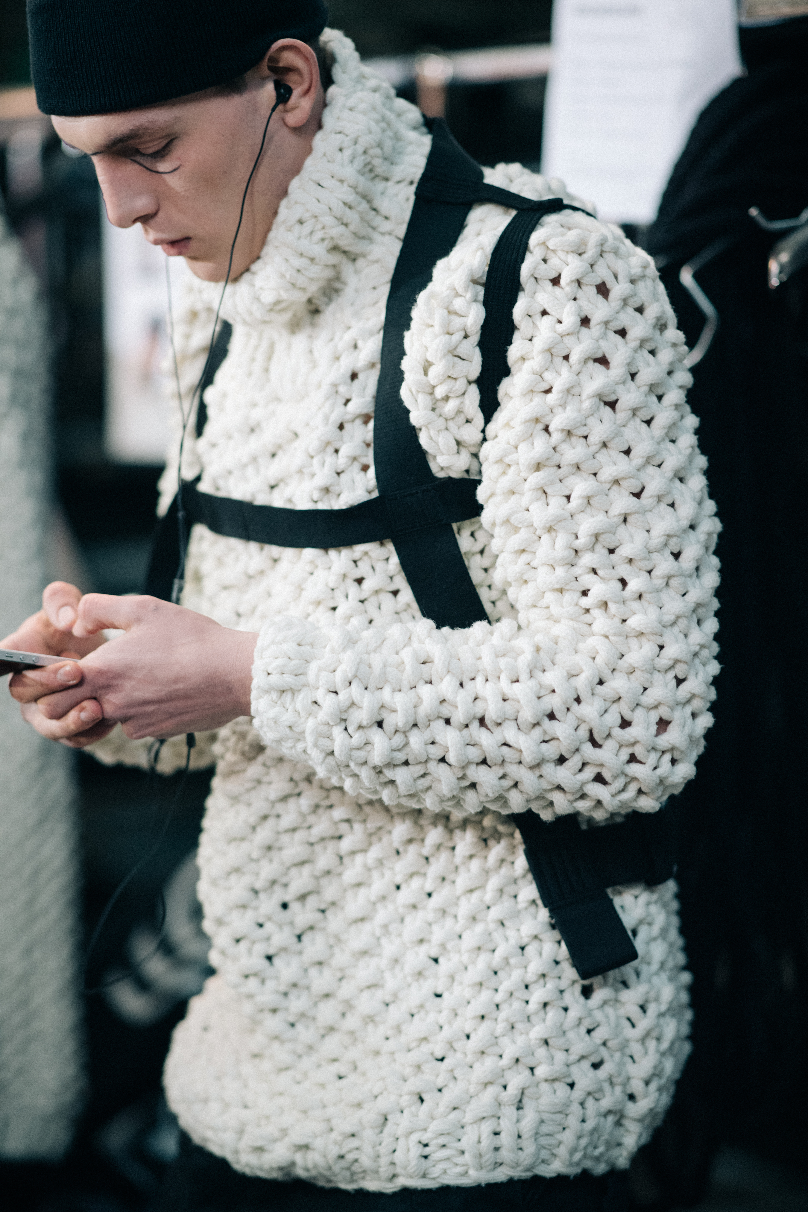 Male model wearing white sweater
