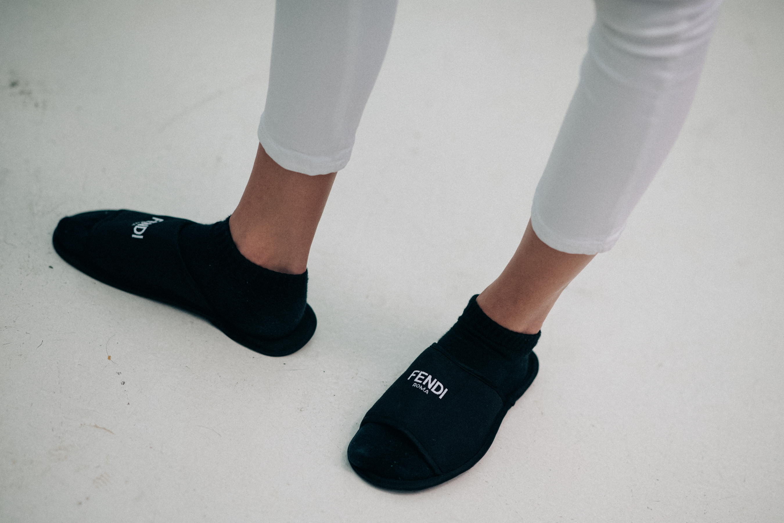 Model wearing branded slippers