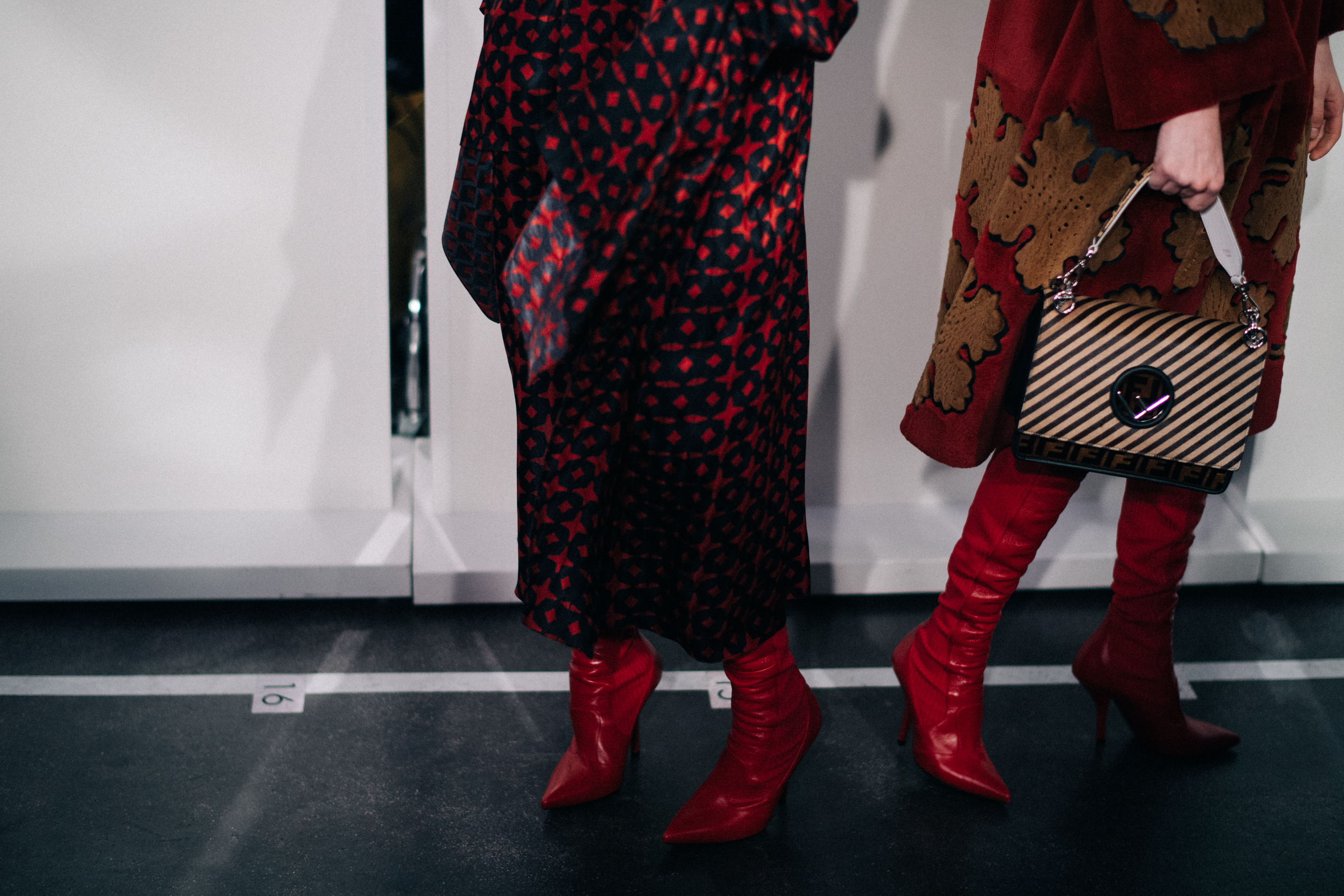 Two models wearing red boots