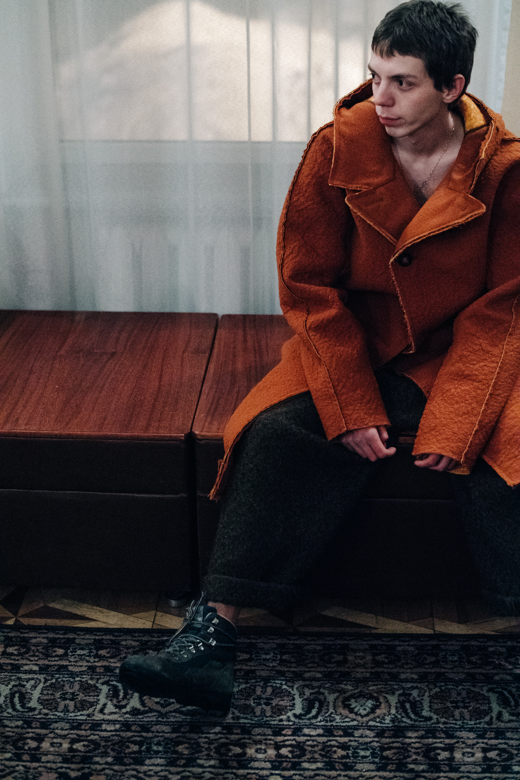 Male model wearing orange coat