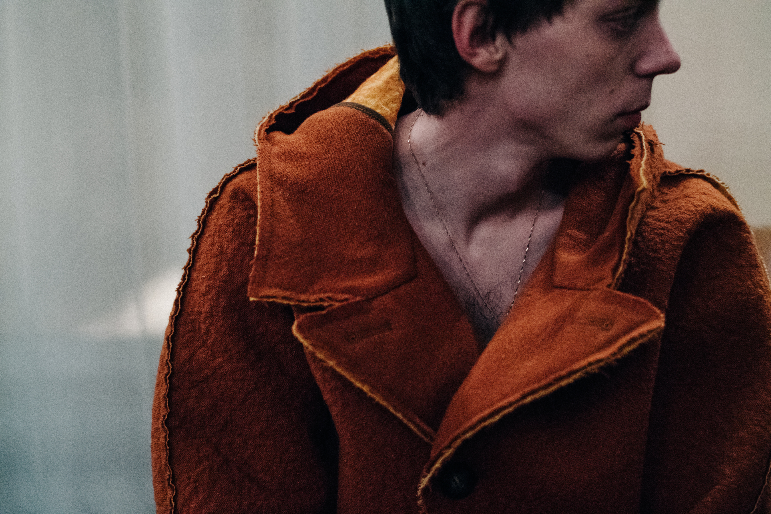 Male model wearing orange coat