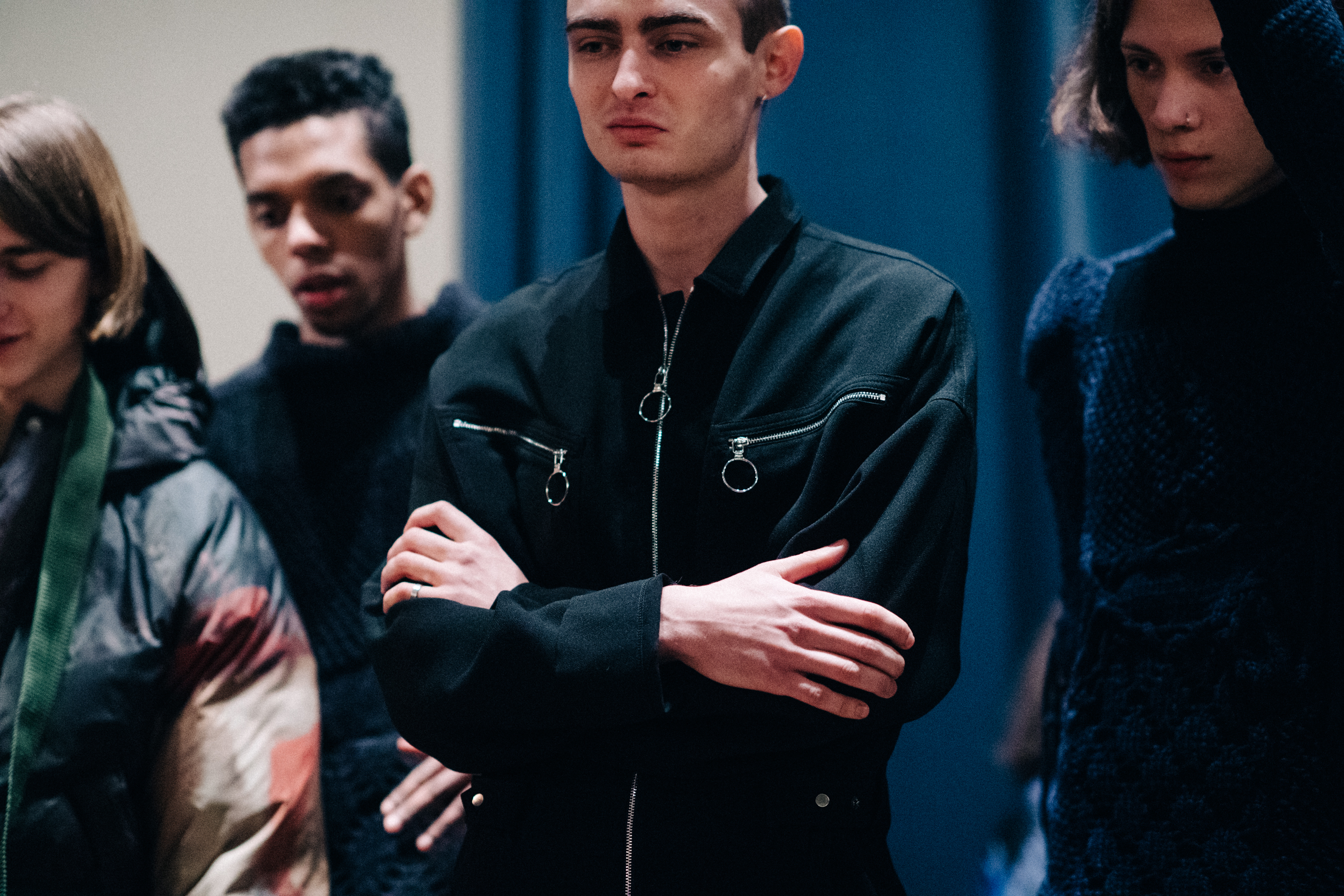 Male model wearing black jumpsuit