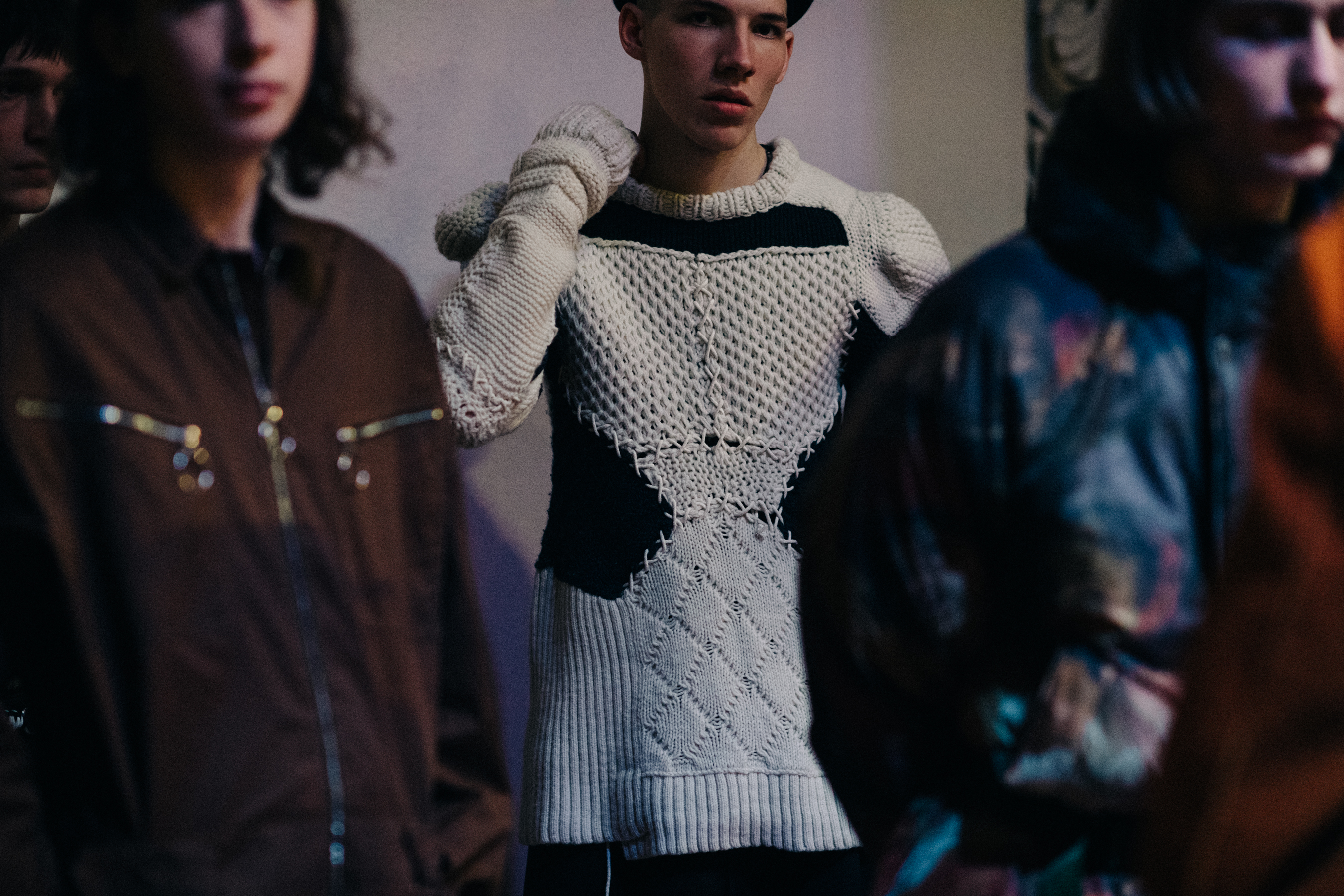 Male model wearing white sweater