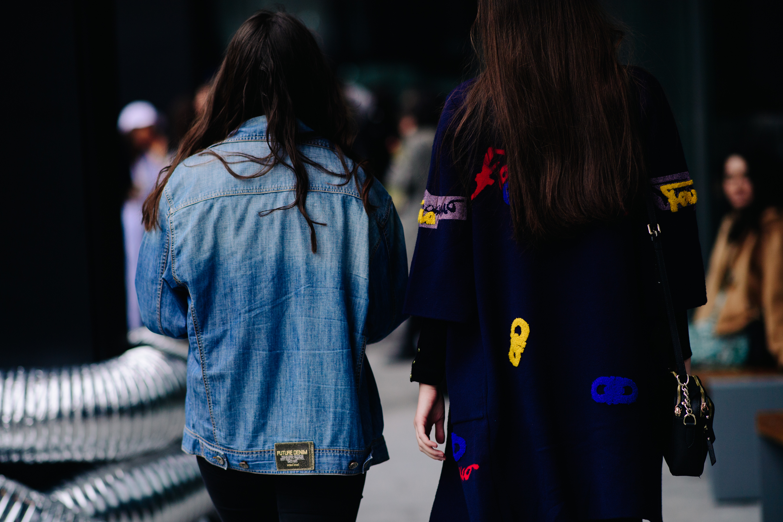 Two women wearing denim jackets