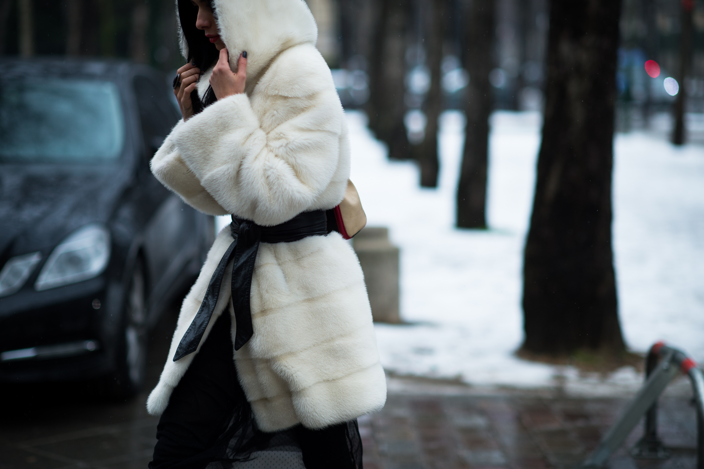 Woman wearing white fur coat