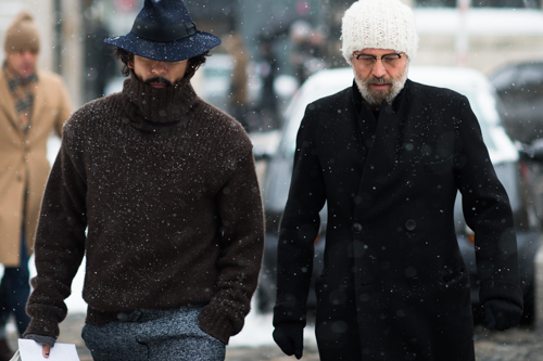 Two men wearing dark clothes