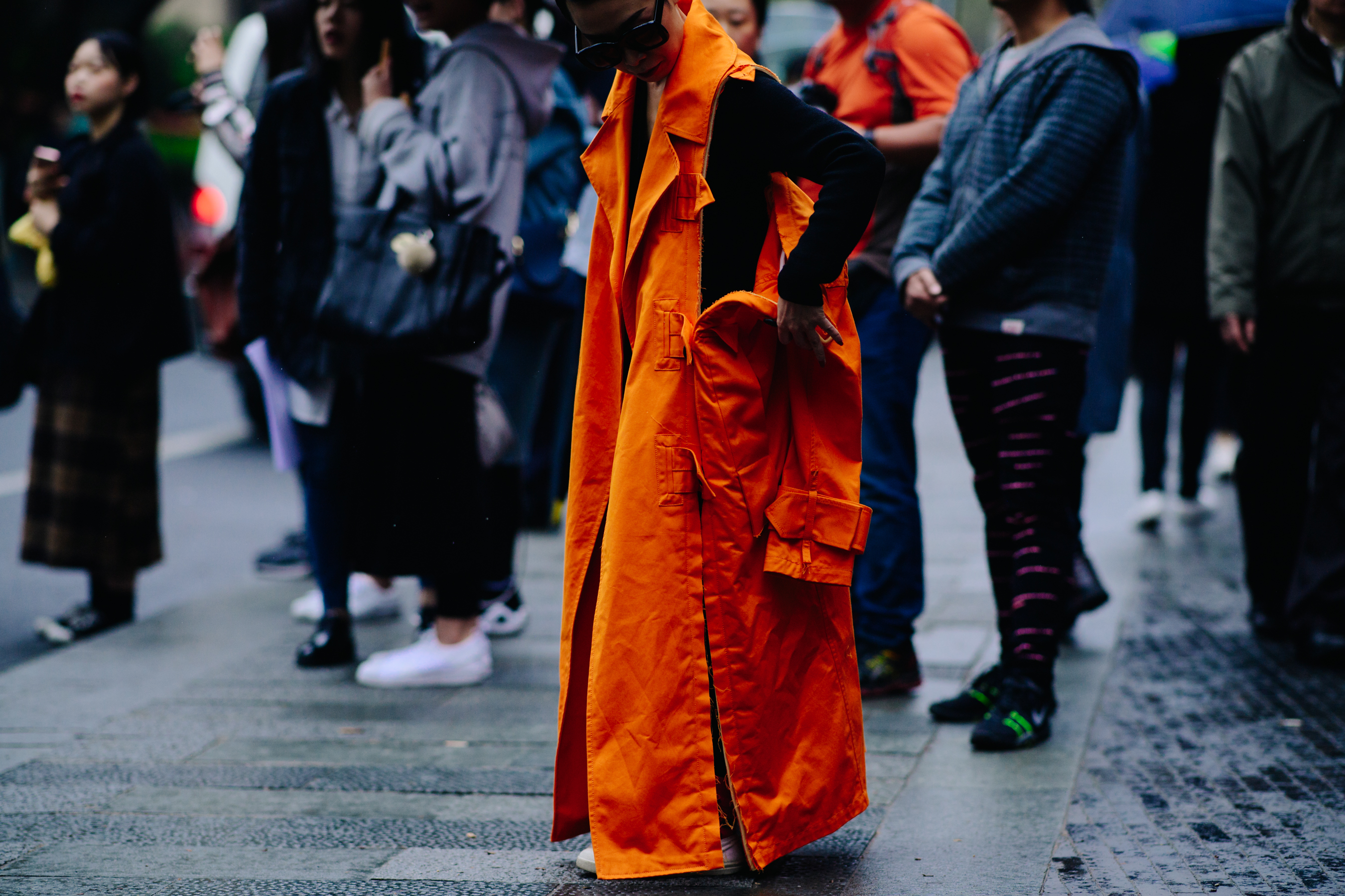 Woman wearing long orange coat