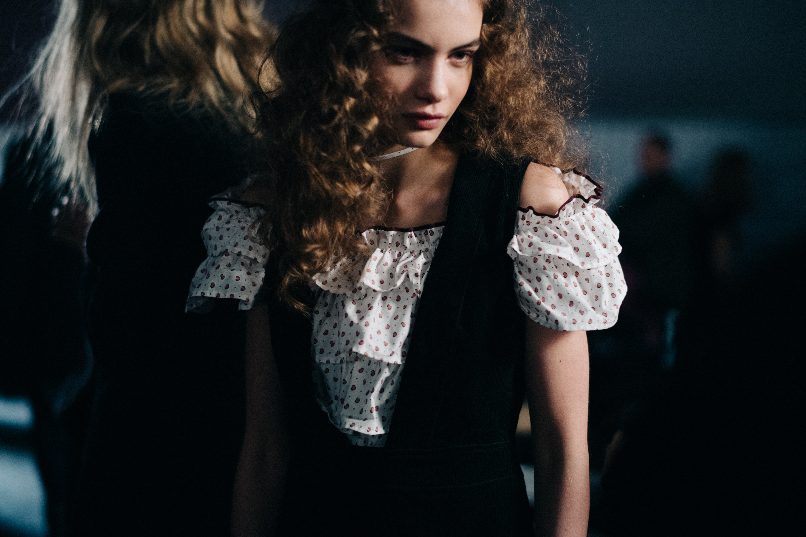 Model wearing white ruffled top