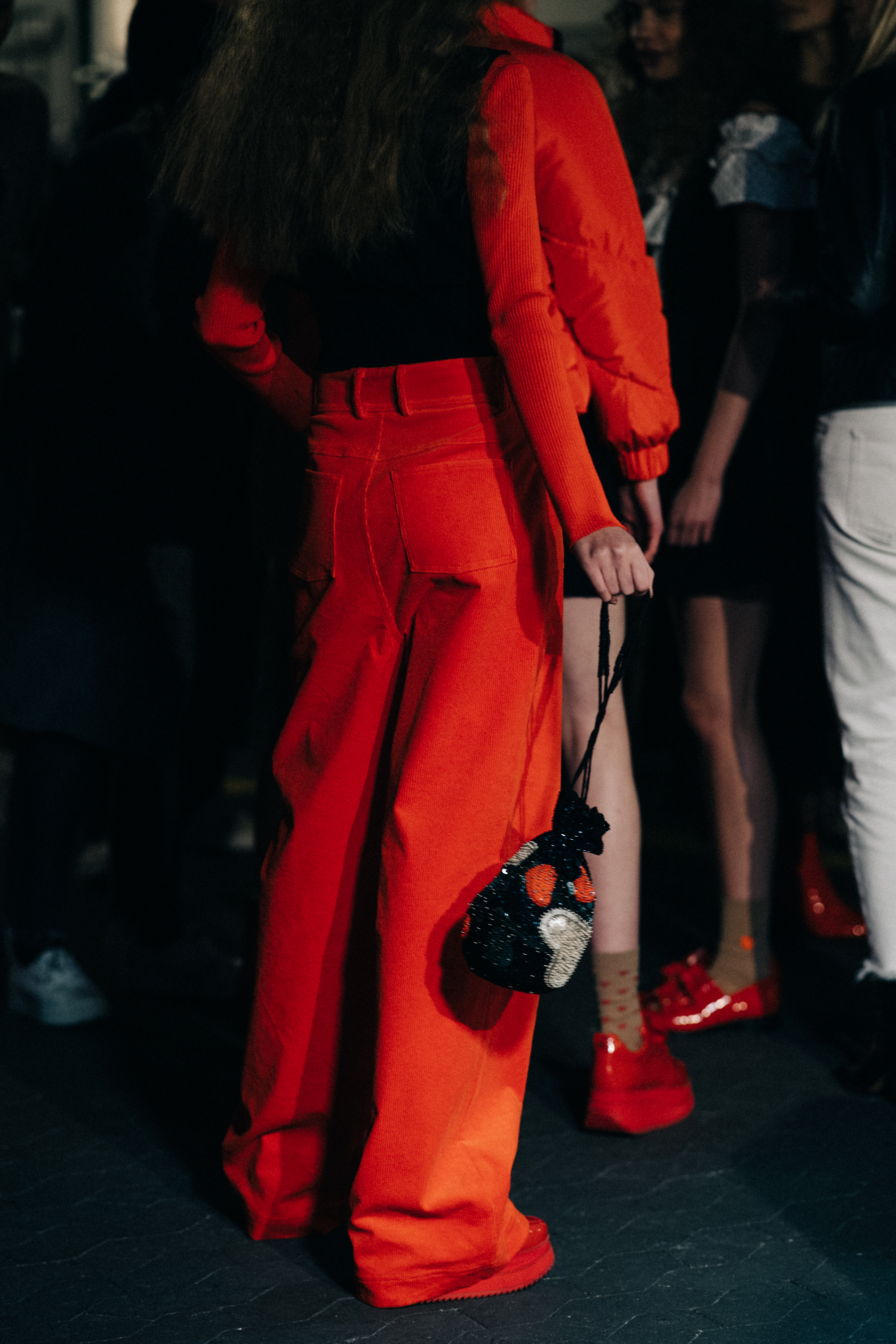 Model wearing red wide leg trousers