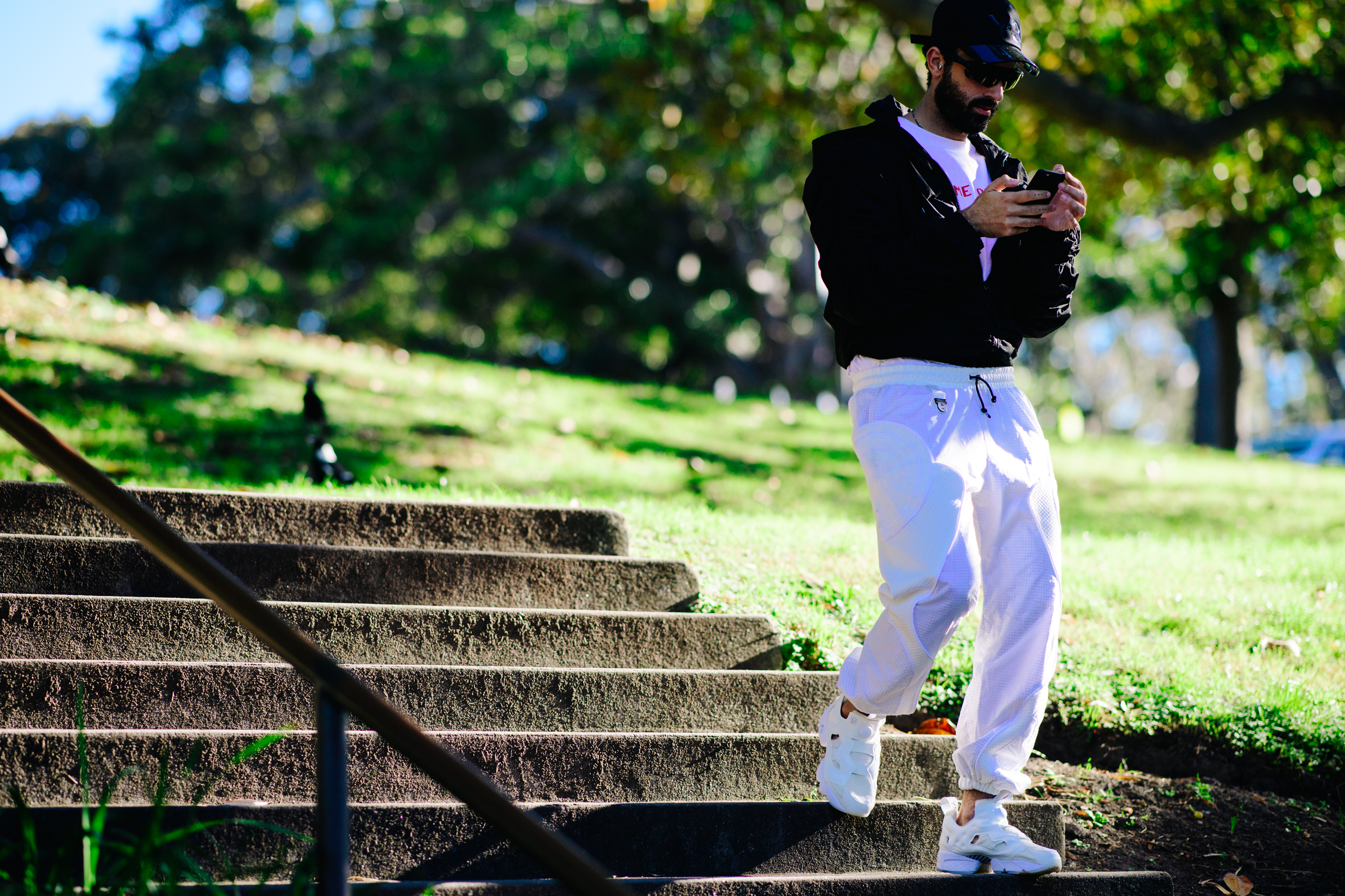 Man wearing white tracking pants