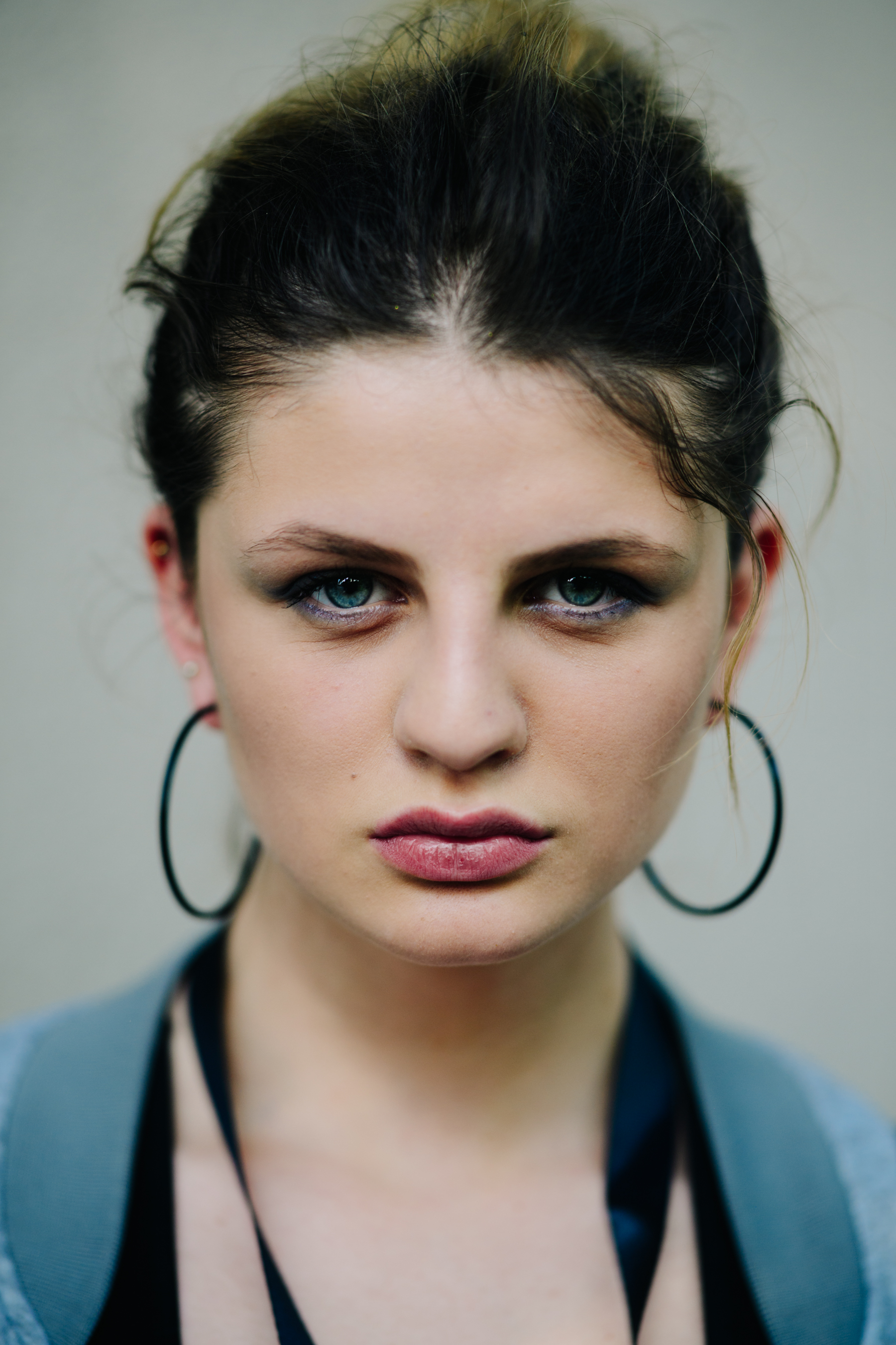 Portrait of a girl wearing black earrings