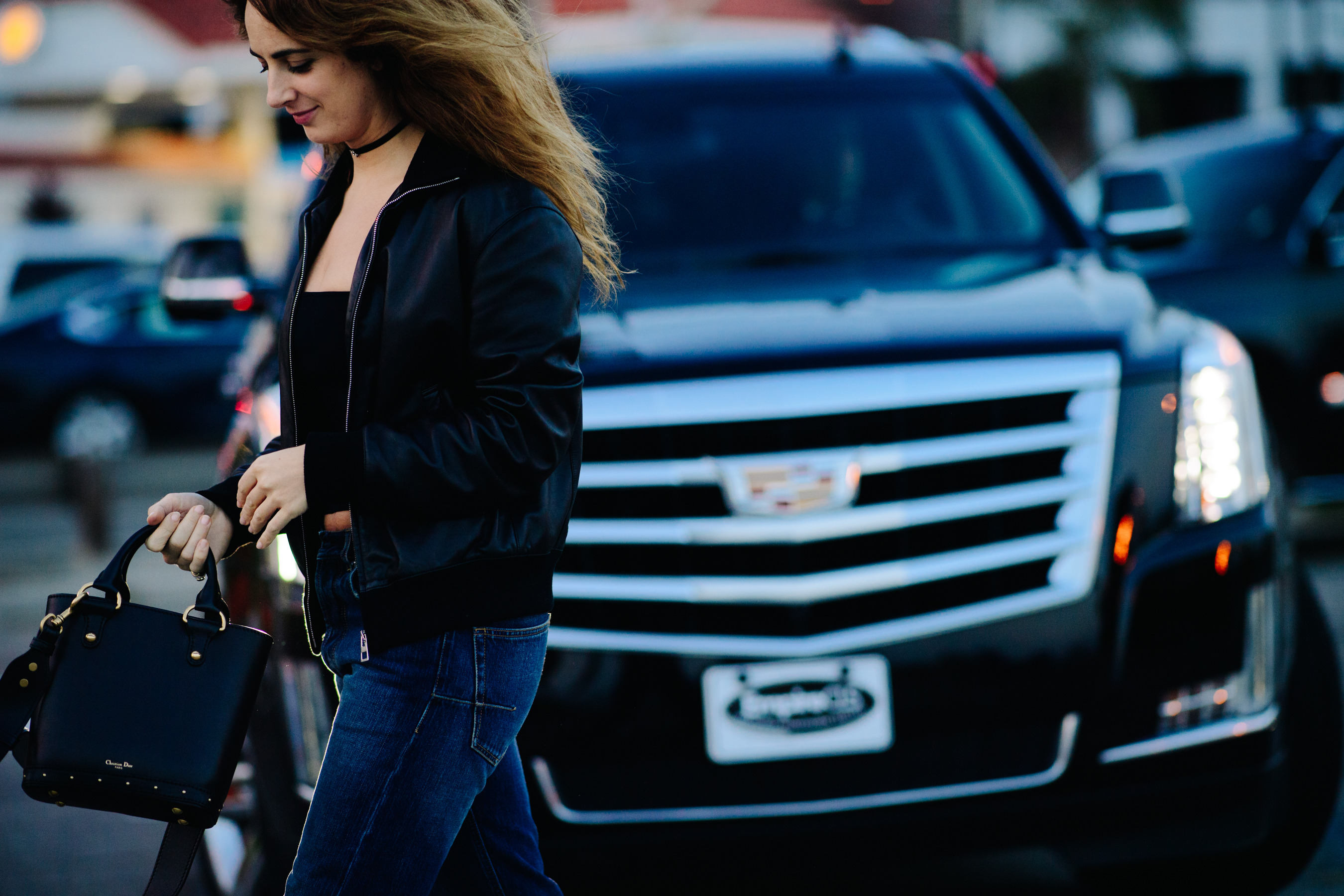 Woman carrying a black Dior bag