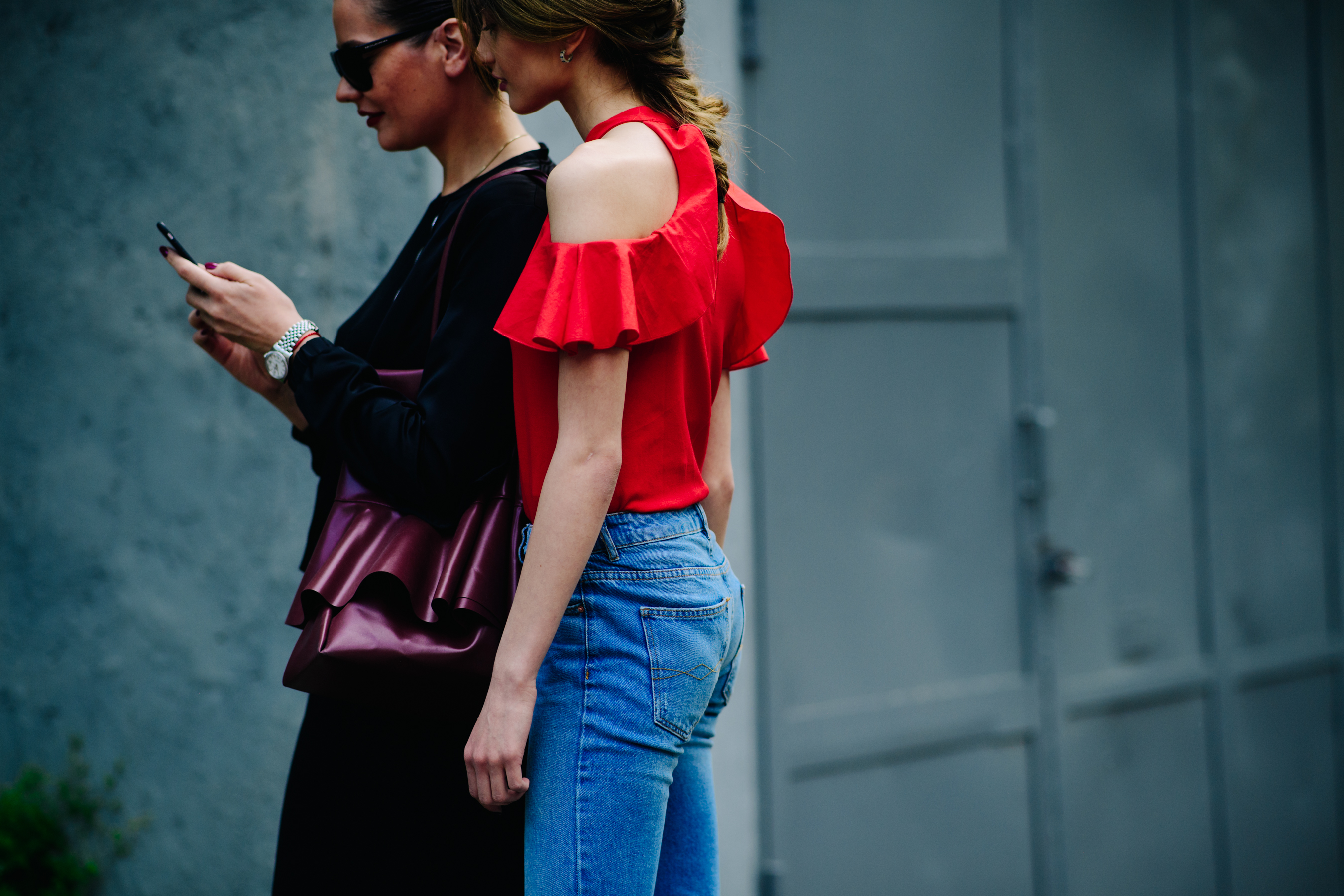 Two women interacting with a phone