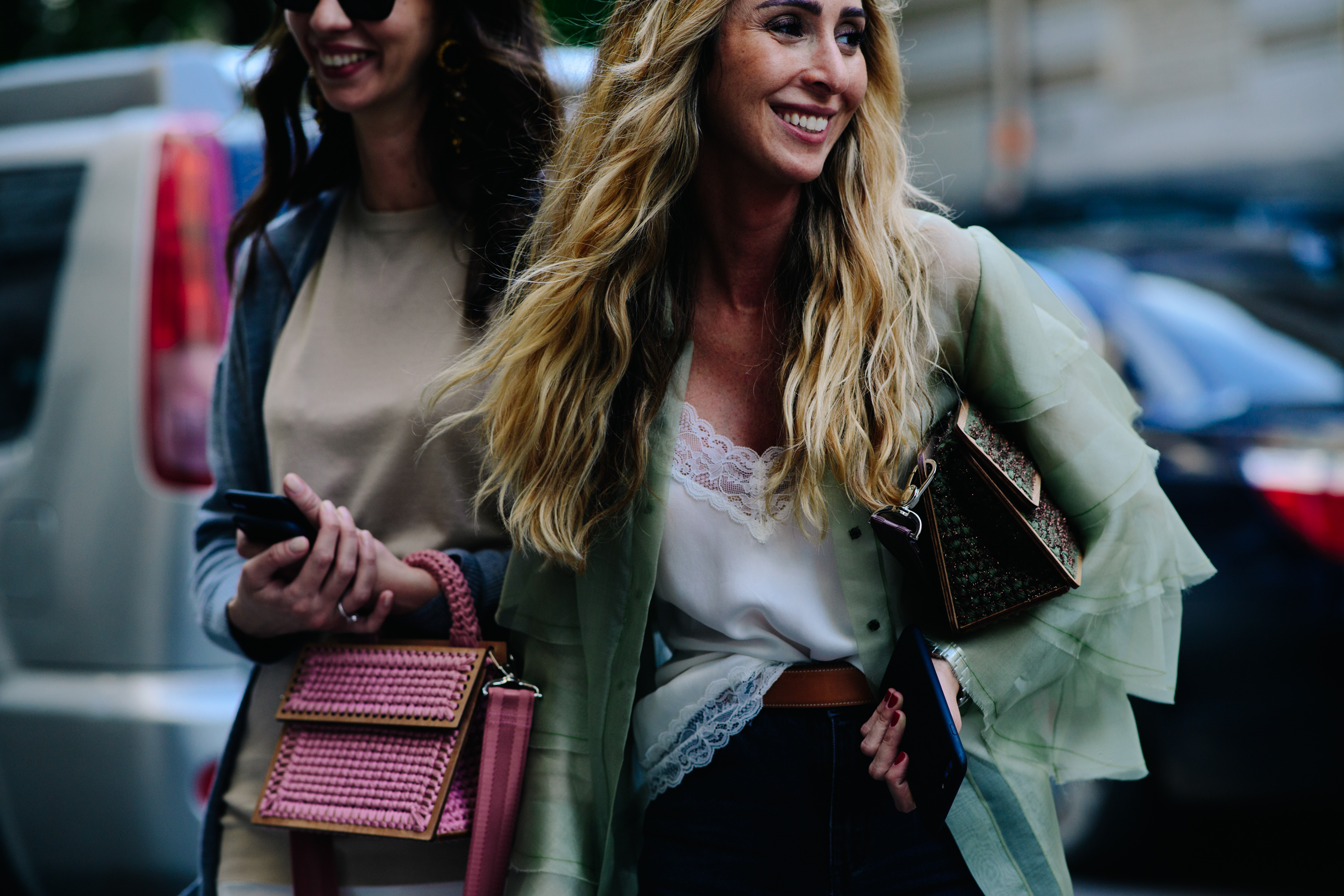 Two smiling women on the street