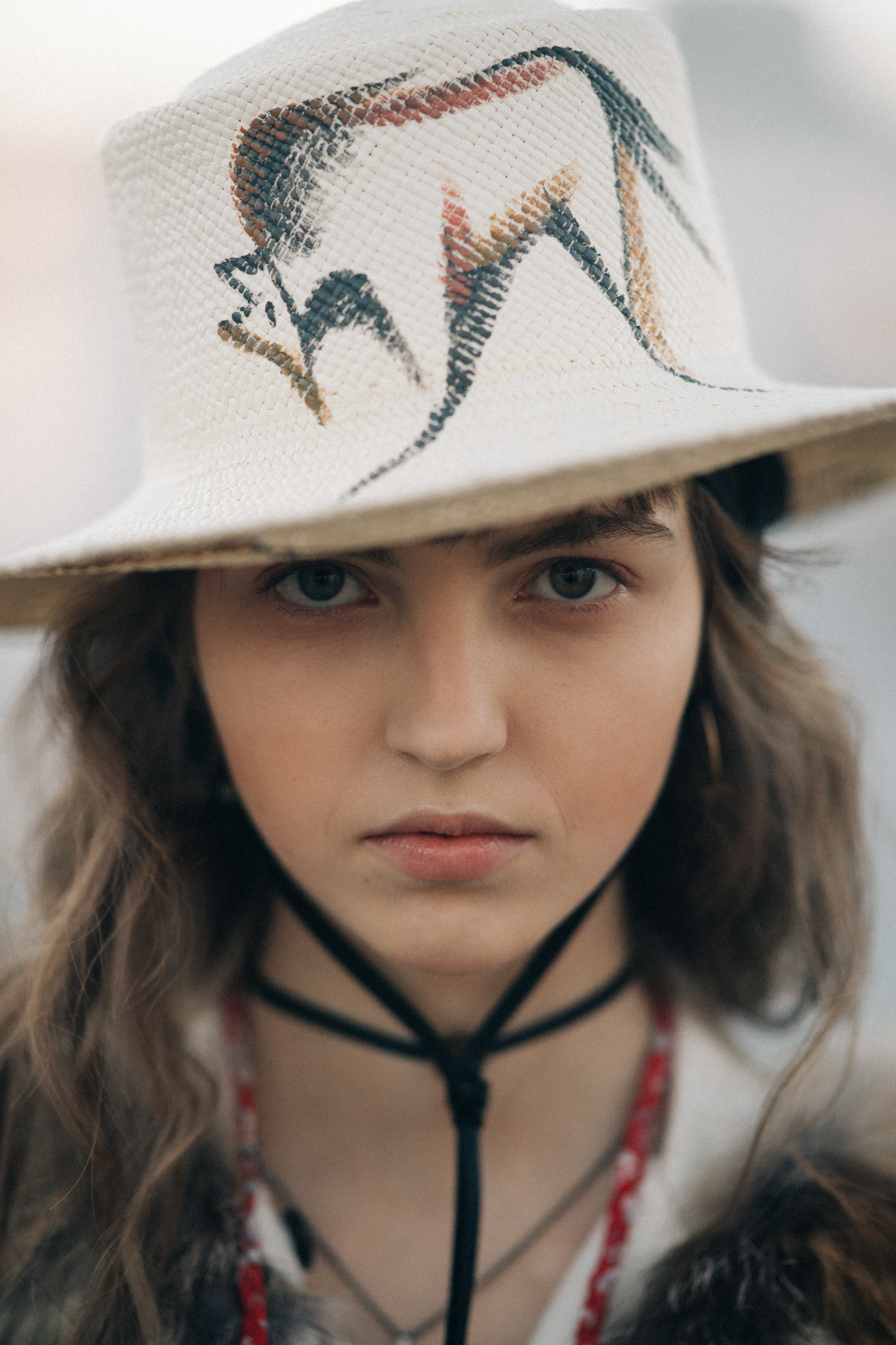 Girl wearing an animal painted hat