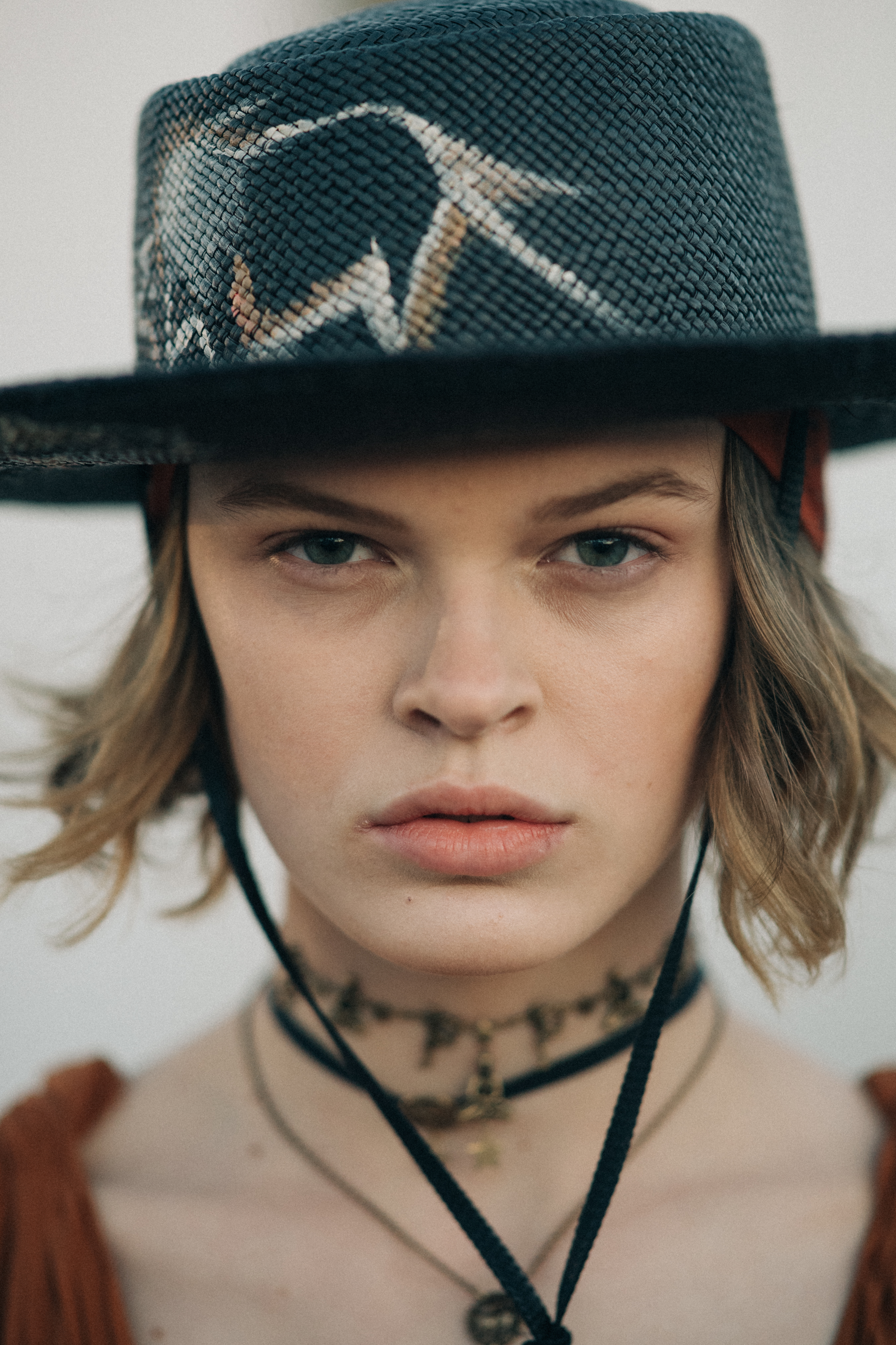 Girl wearing a black straw hat