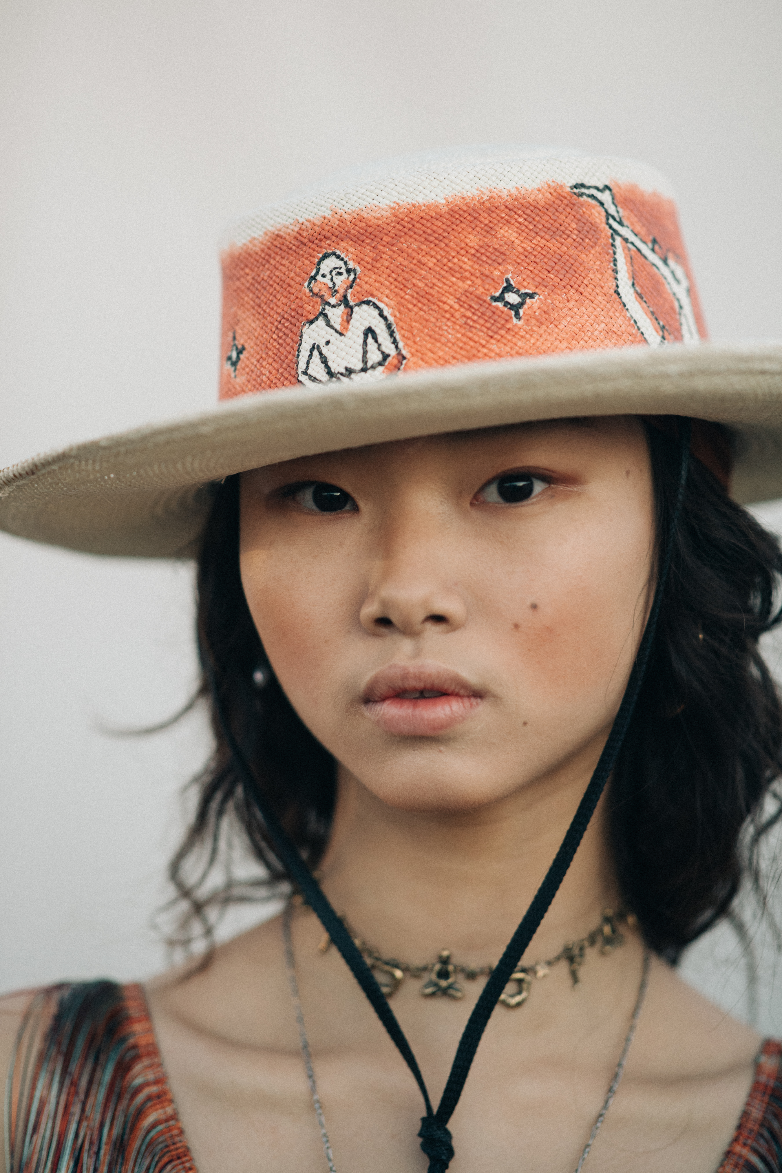 Asian model wearing a Buddha necklace