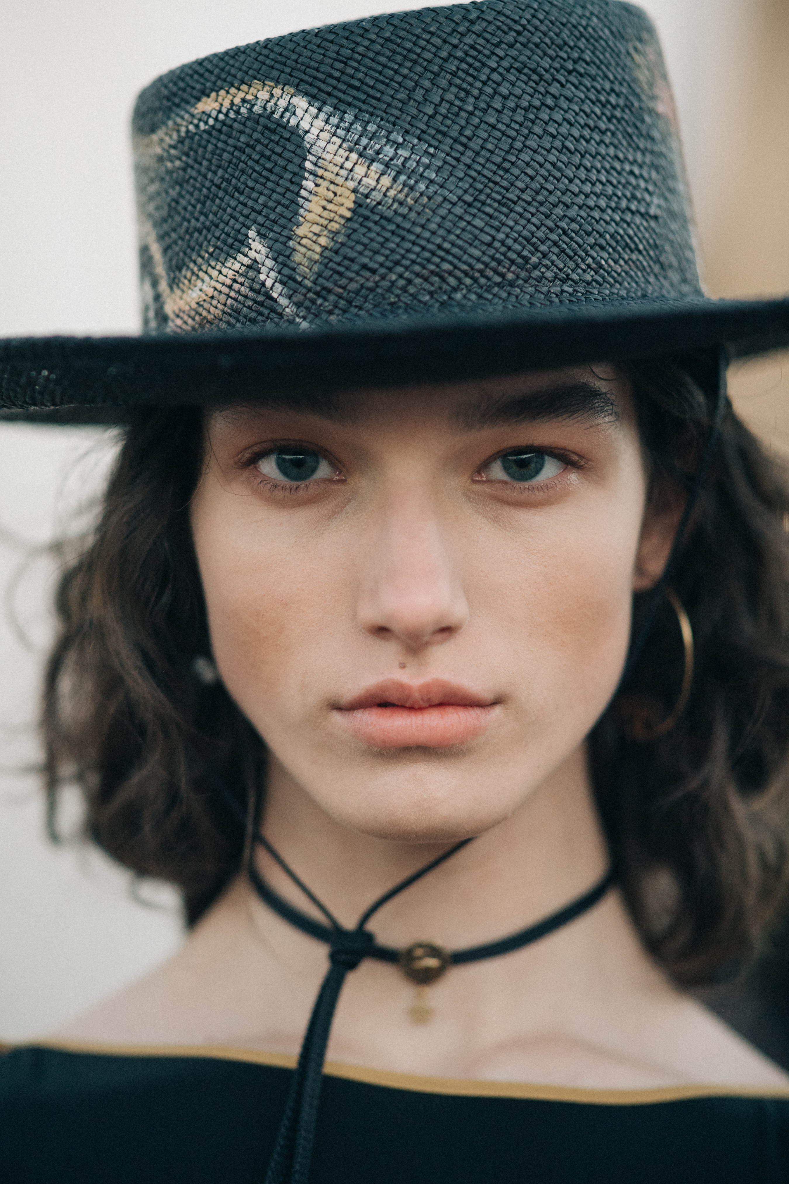 Girl wearing a black straw panama