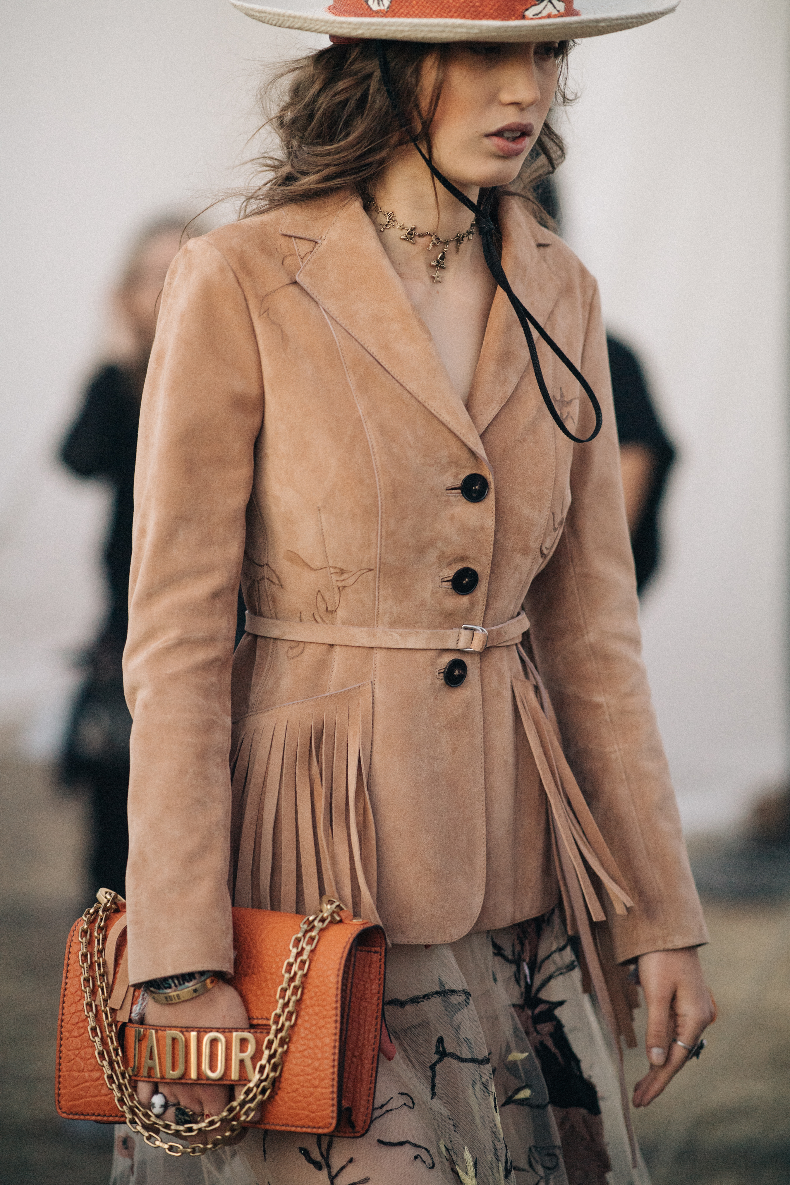 Girl holding an orange leather purse