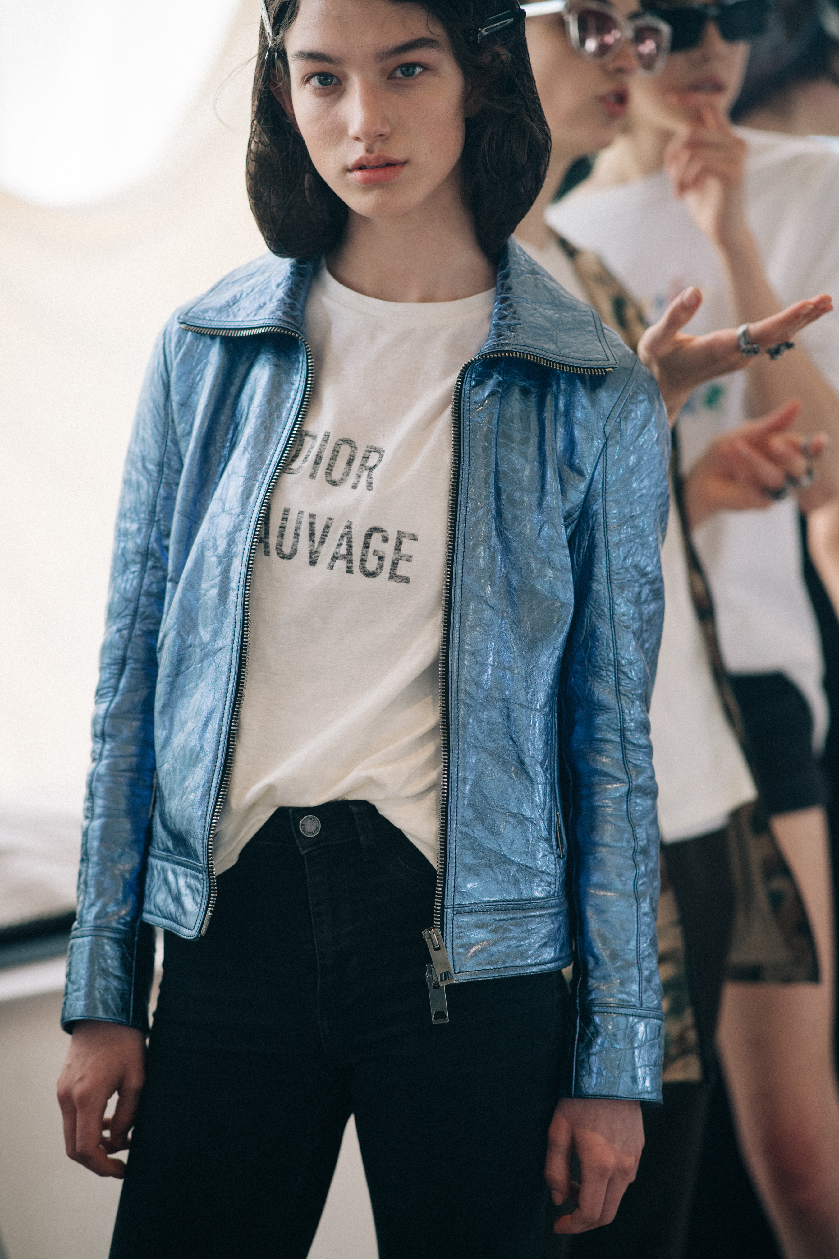 Girl wearing a metallic blue jacket