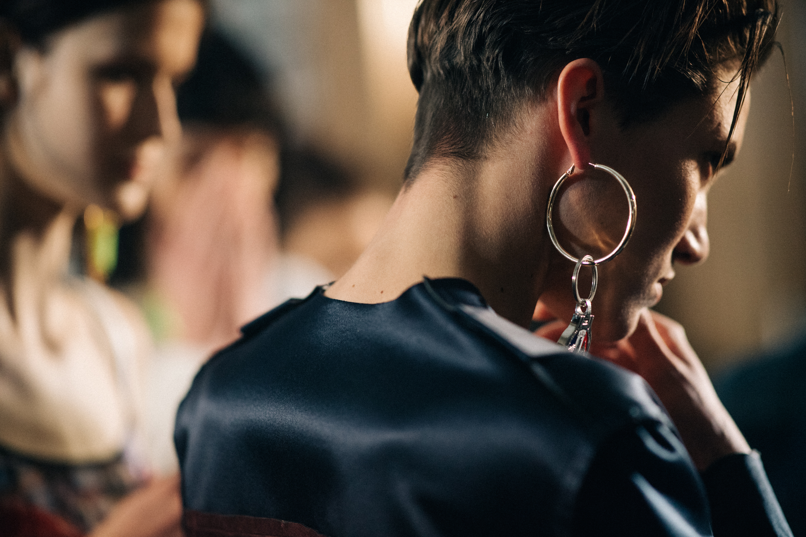 Model wearing a large silver earring