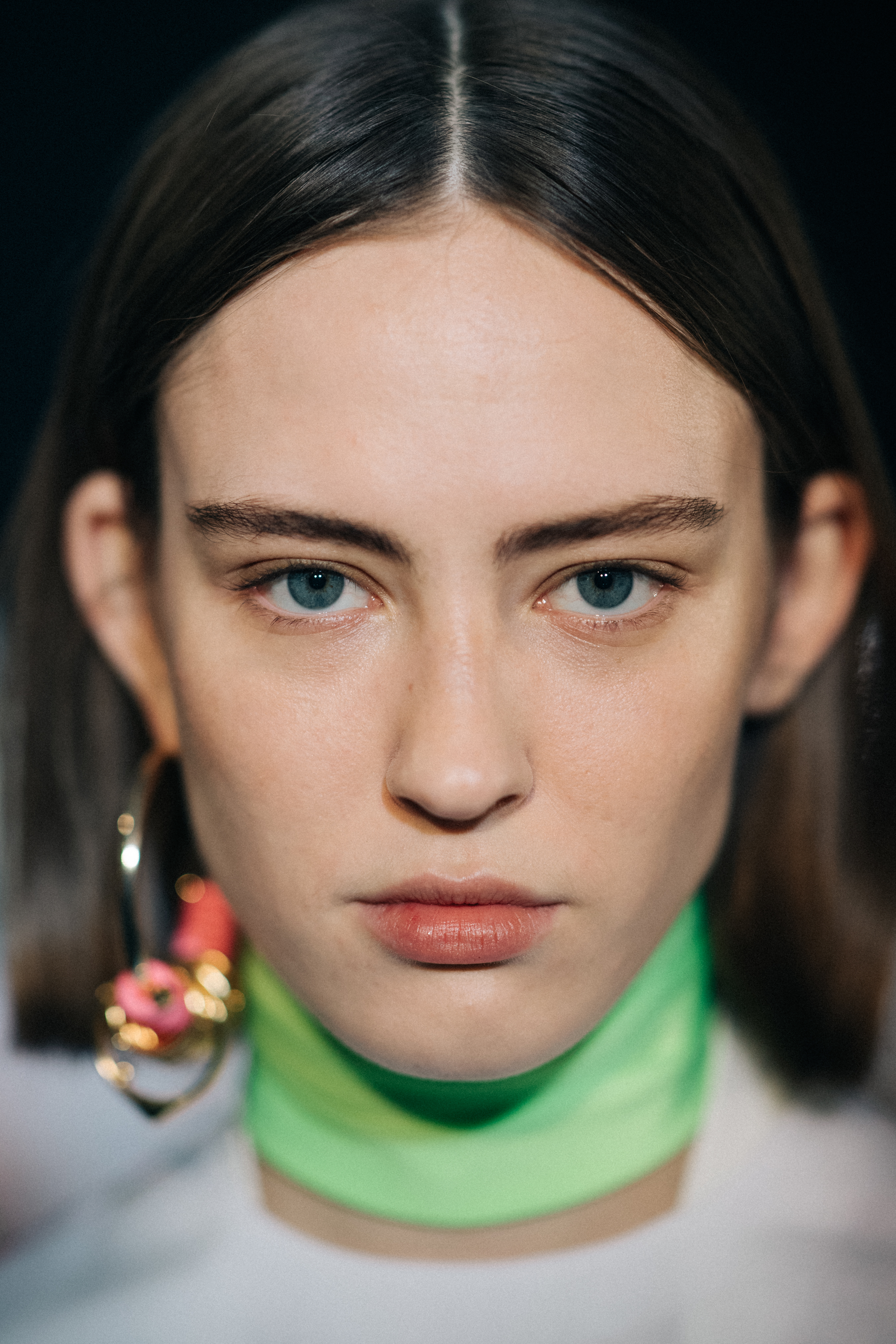 Model wearing a green choker