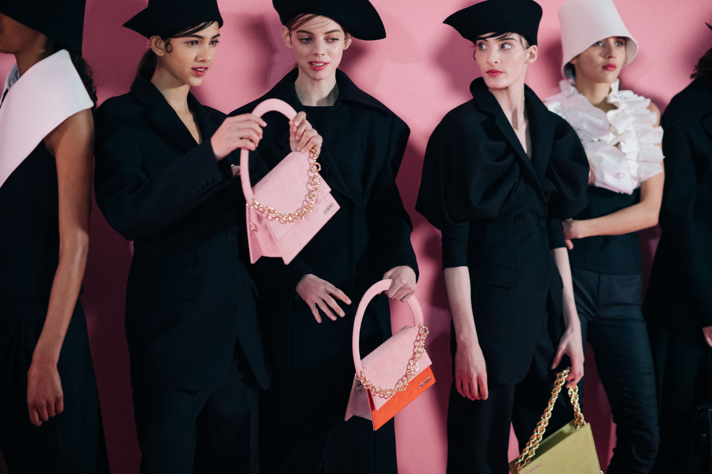 Girls holding pink leather Jacquemus bags