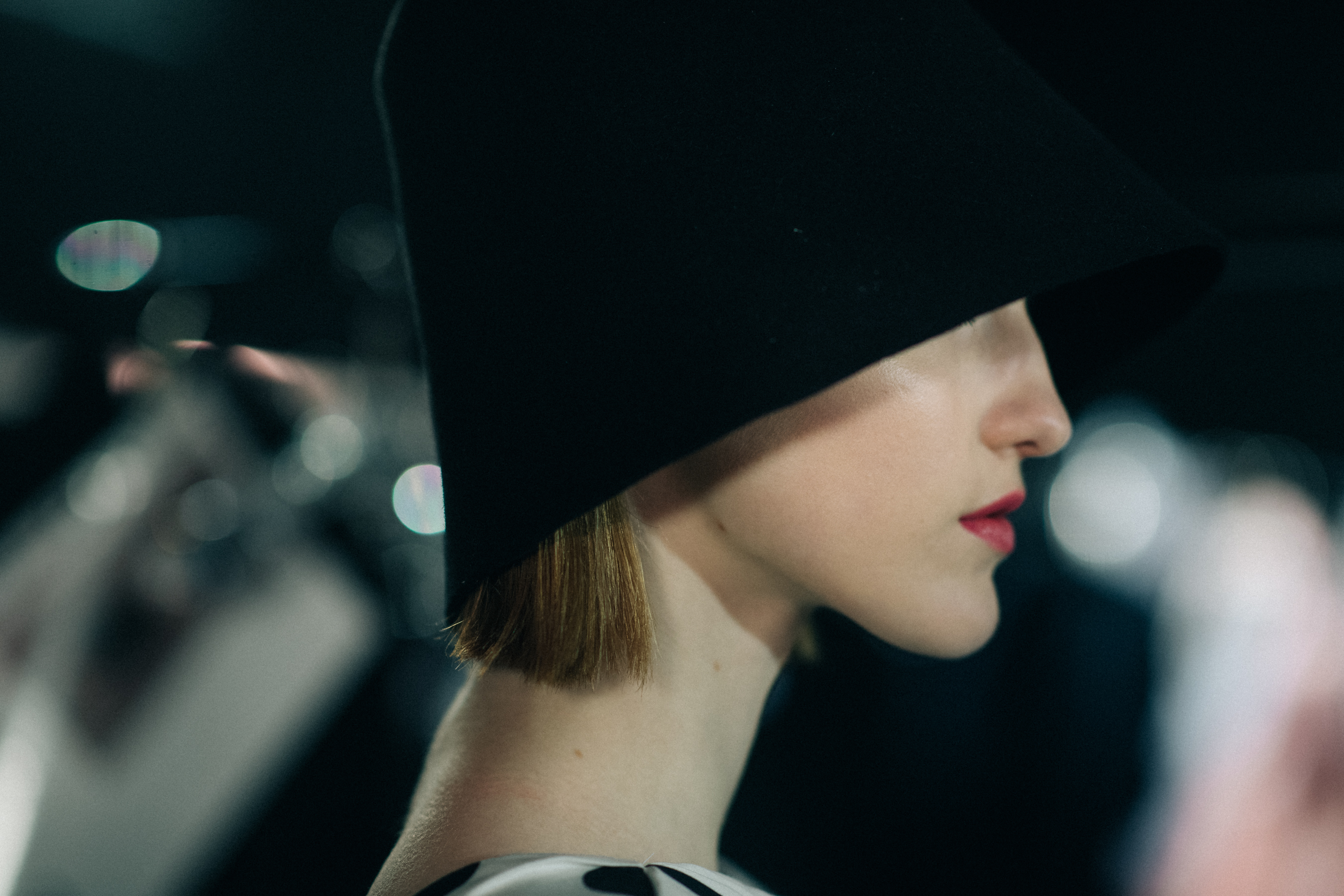 Profile of a girl wearing a bell hat