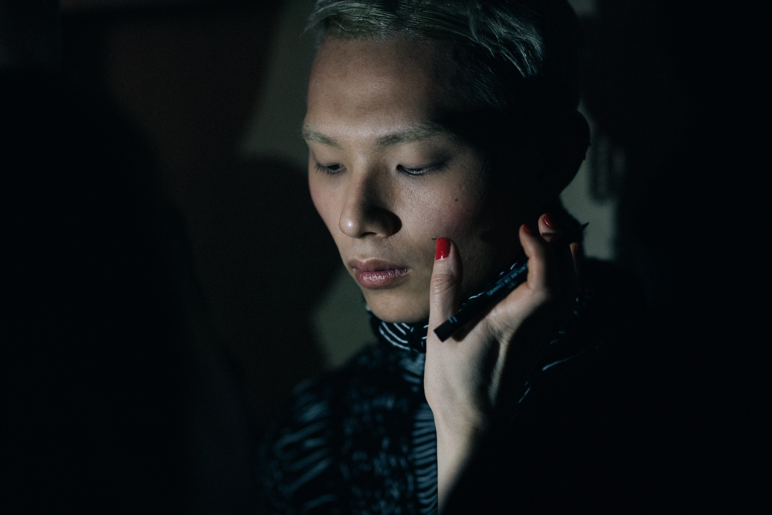 Male model getting make up done