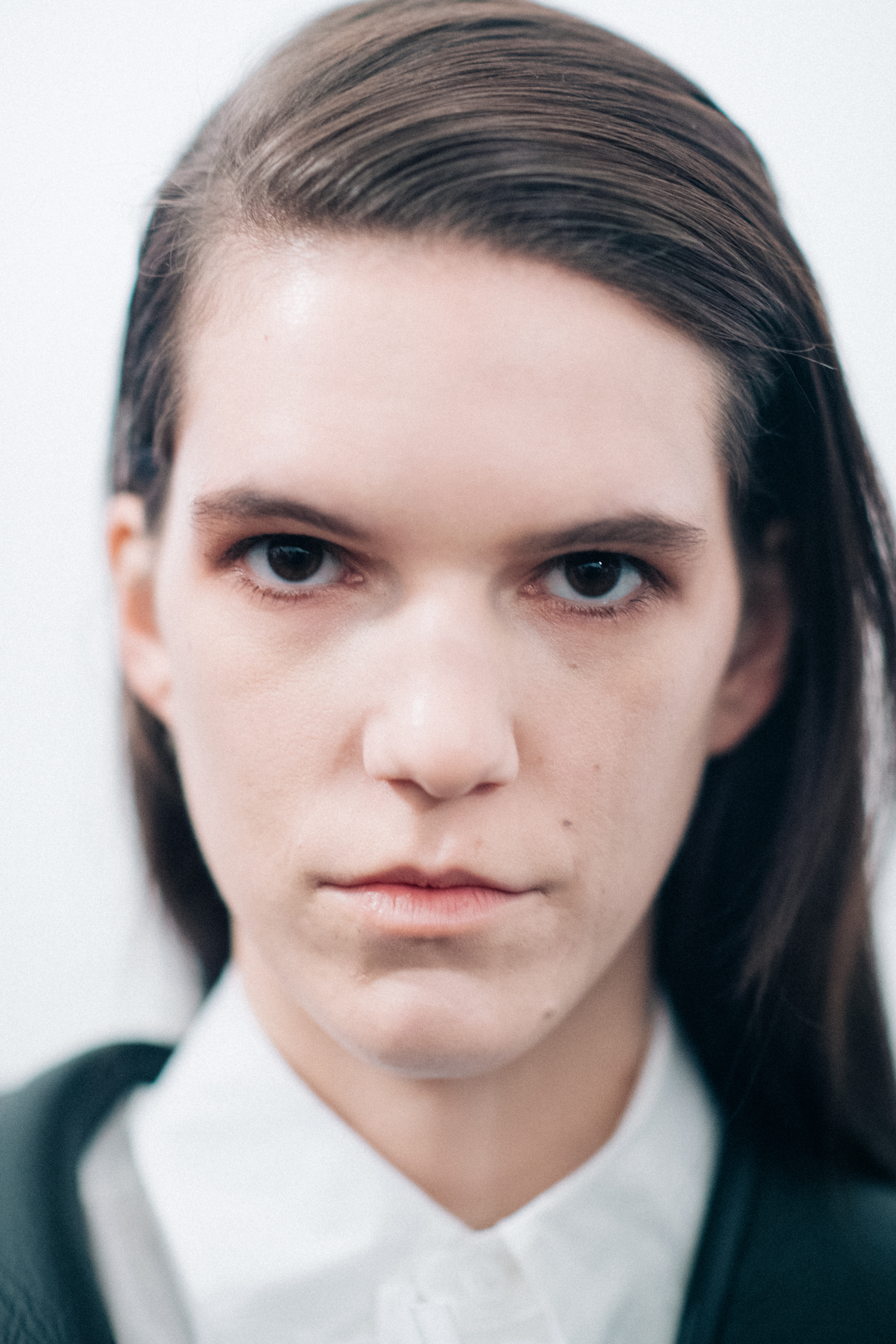 Model wearing a white buttoned shirt