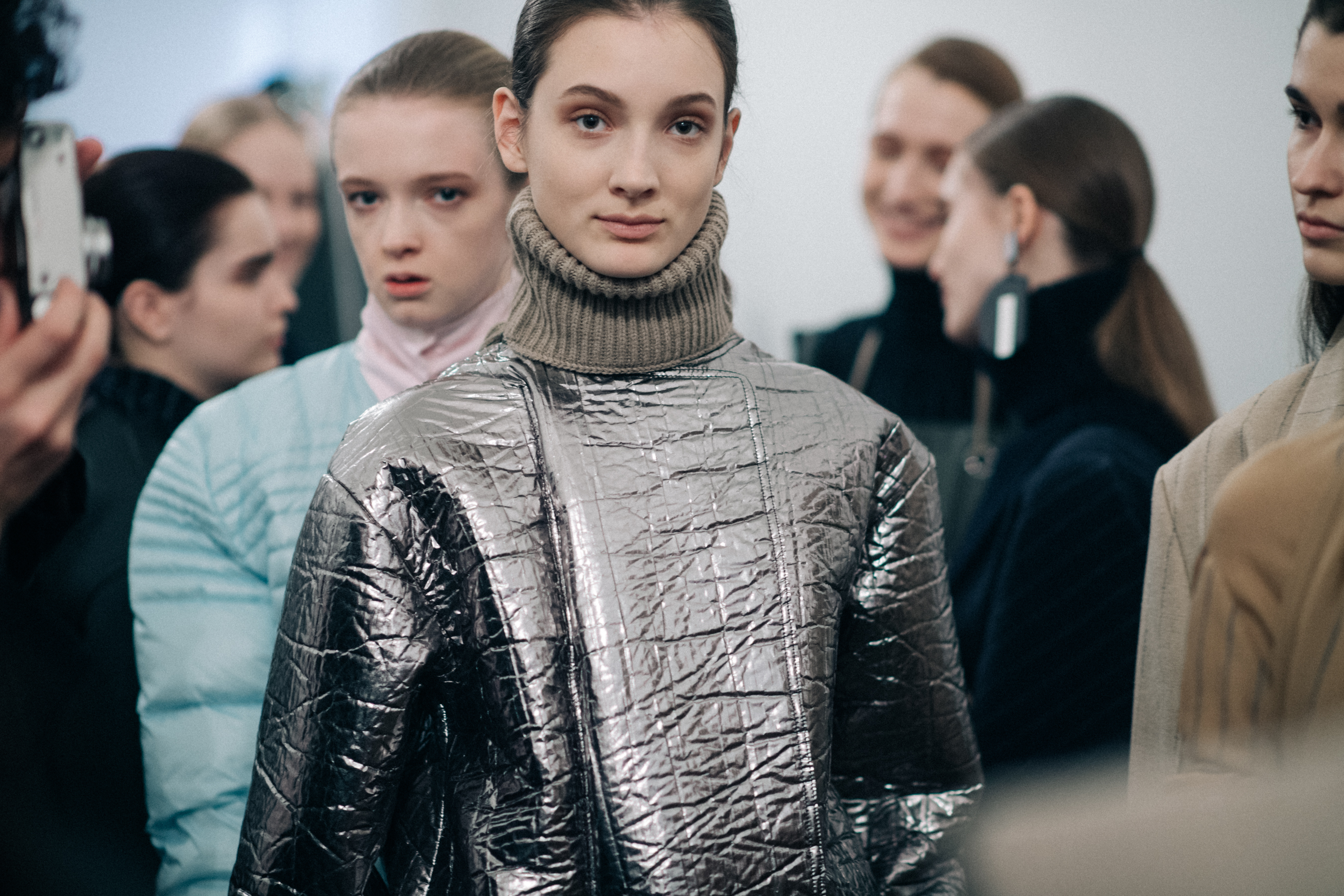 Model wearing a metallic turtleneck