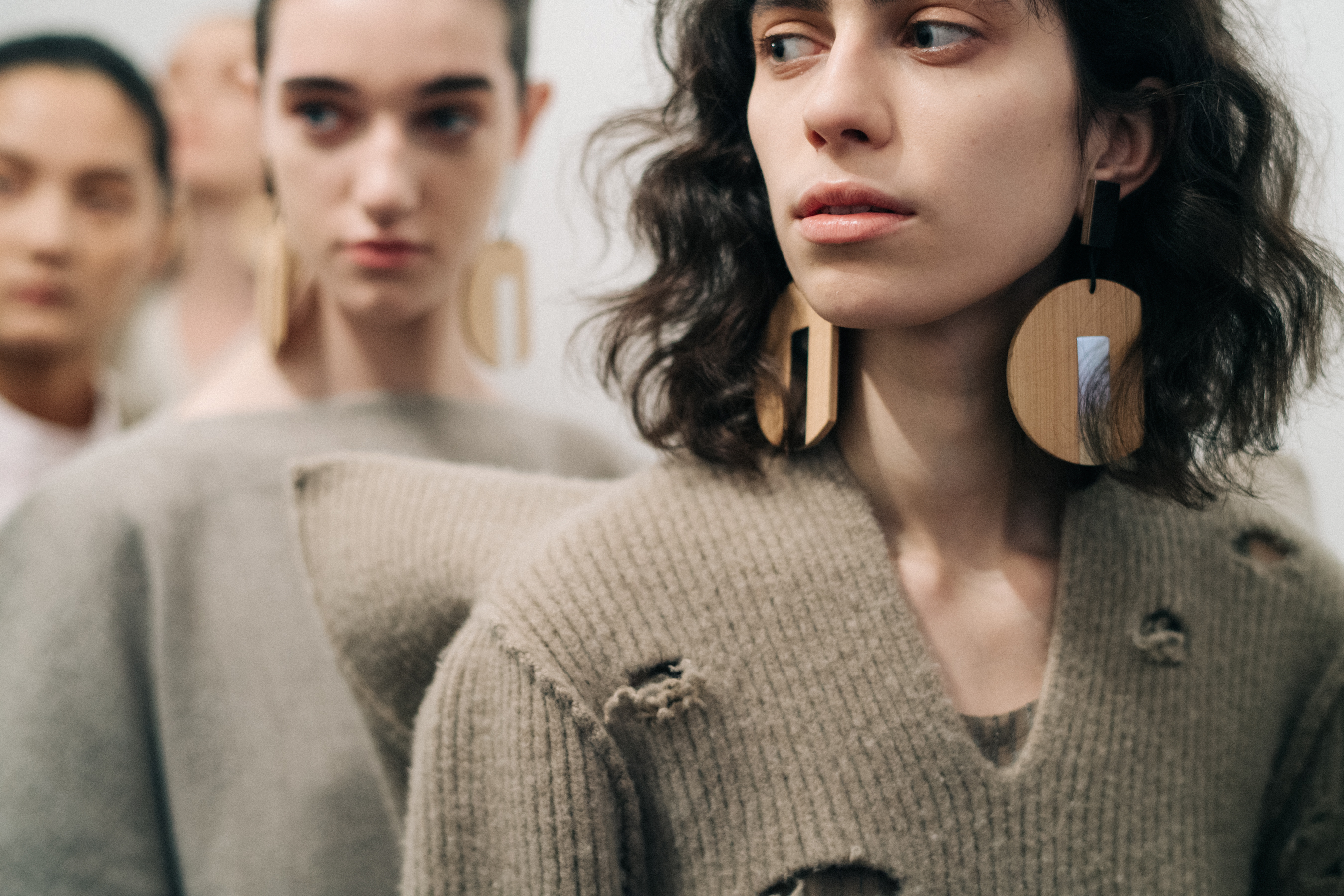 Model wearing a distressed sweater