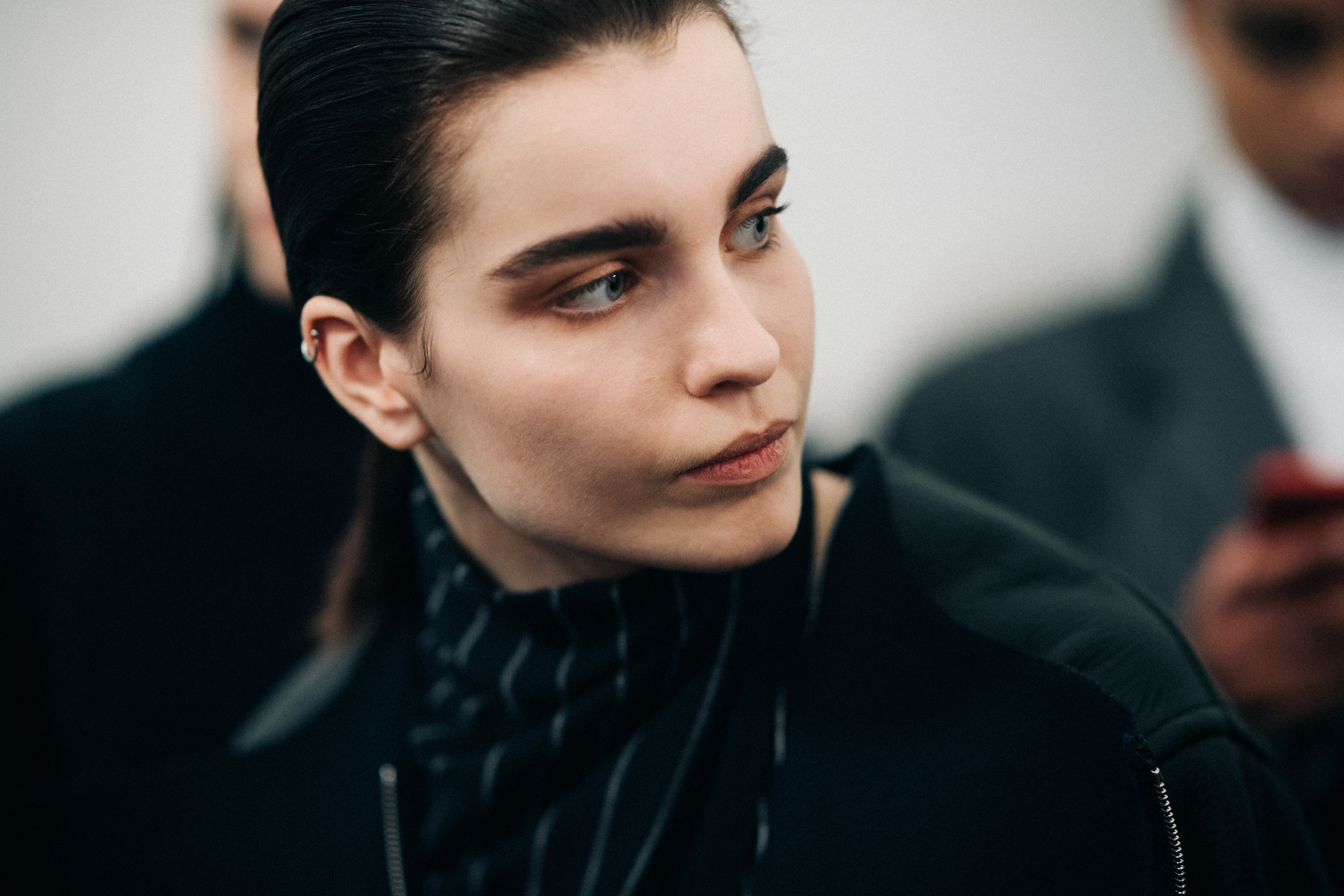 Model wearing a black striped turtleneck