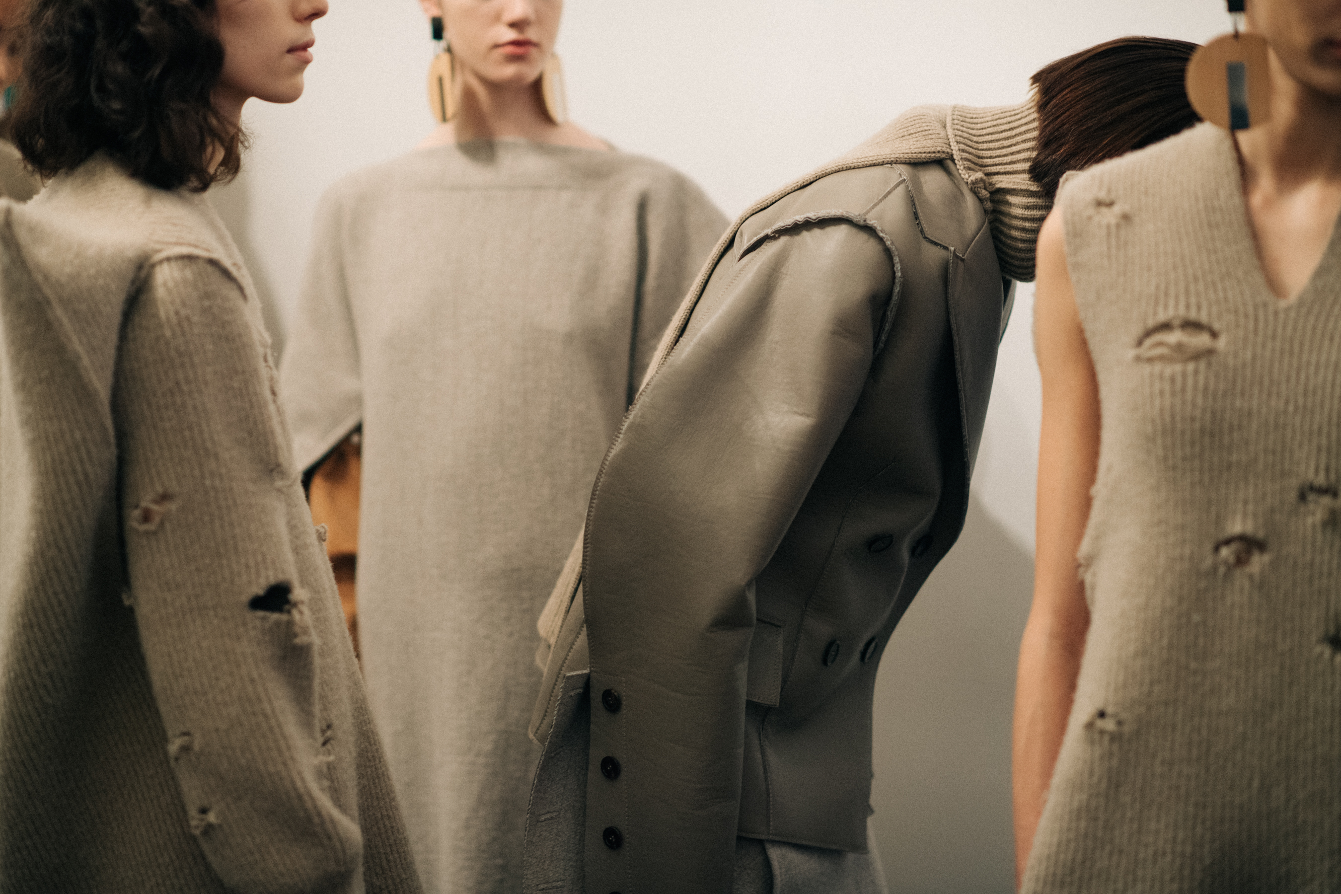 Models wearing distressed wool garments