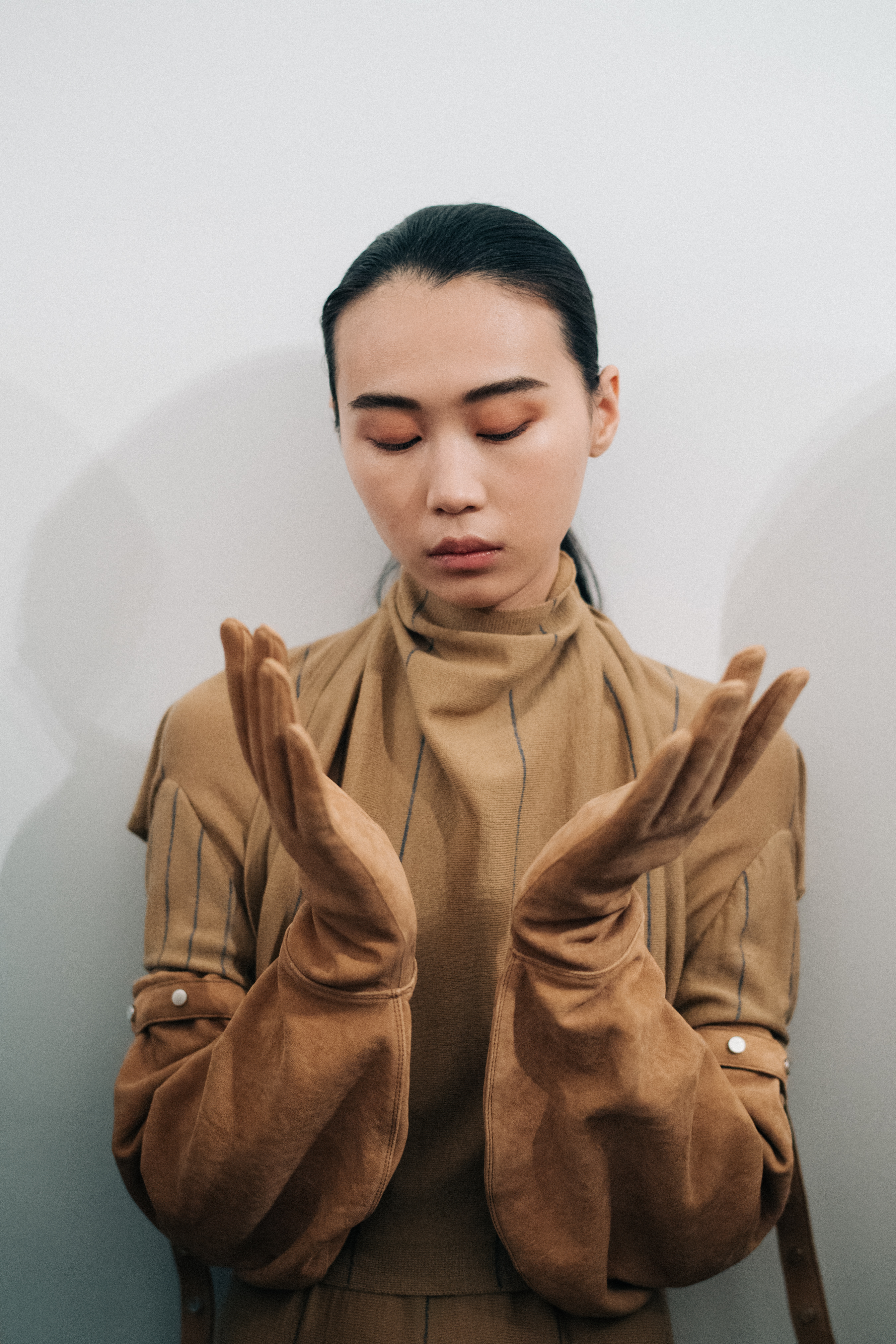 Asian model wearing suede Nehera gloves