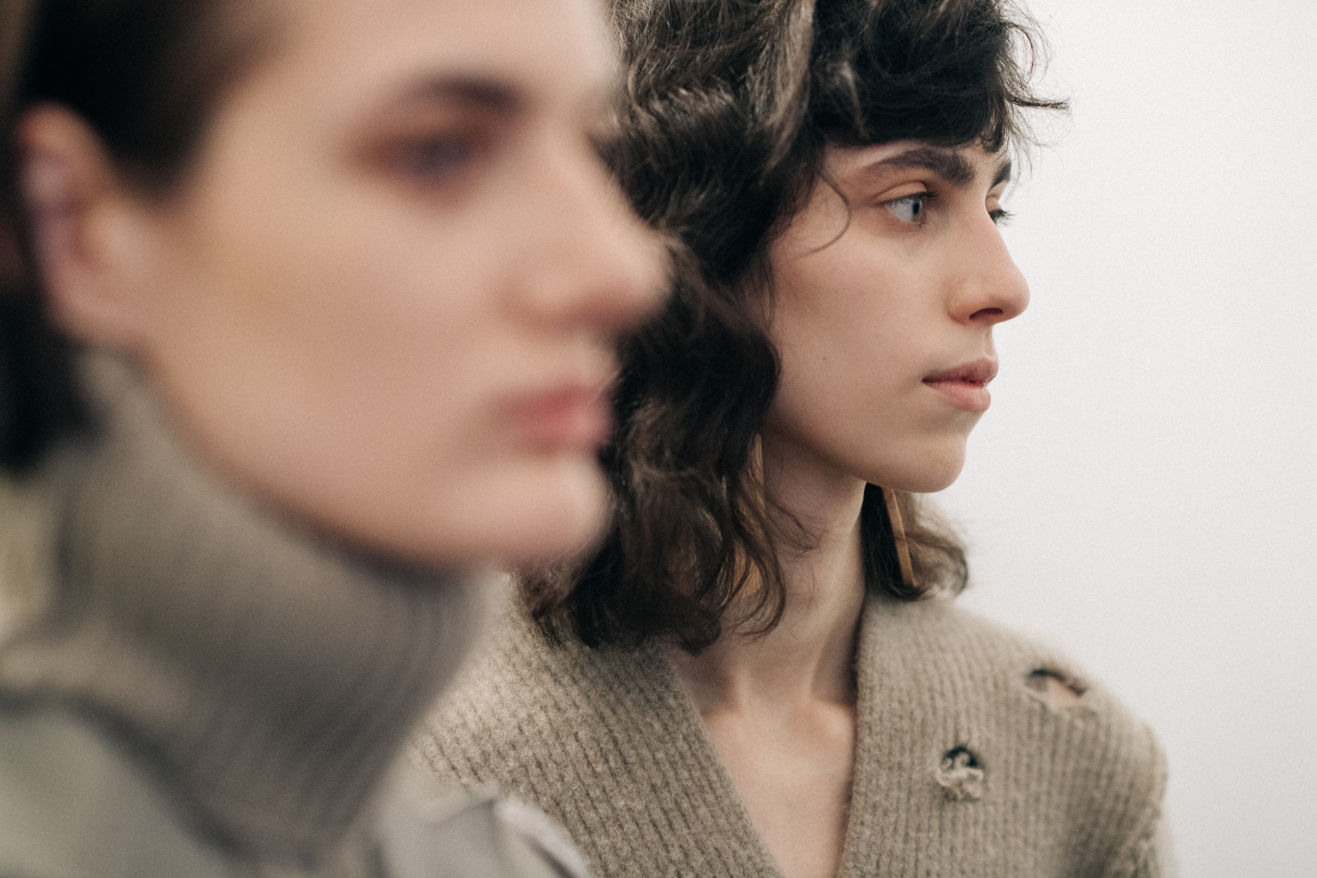 Model wearing a distressed wool sweater