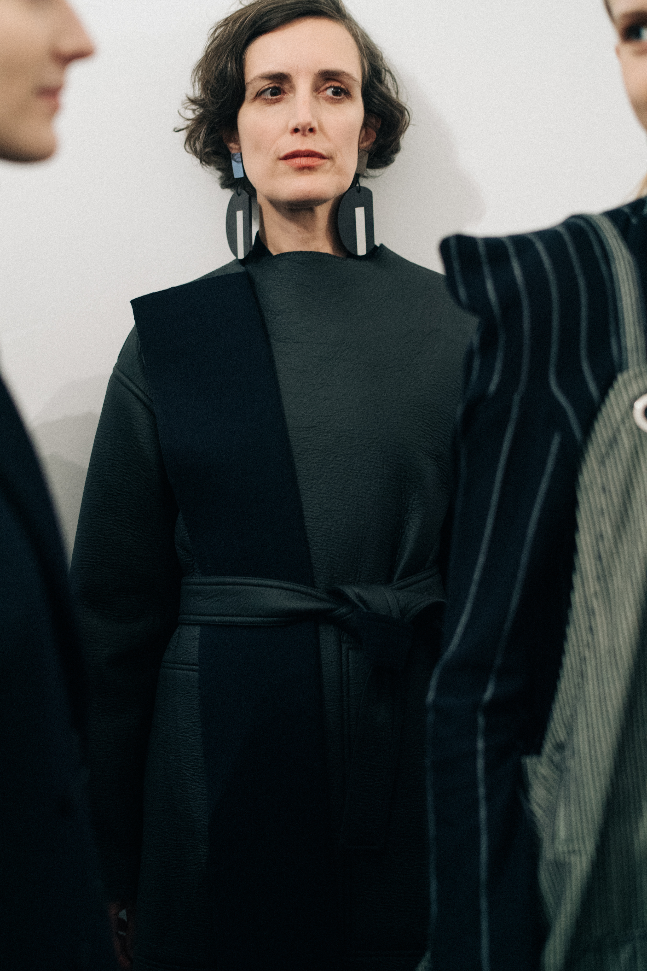 Mature female model wearing a black coat