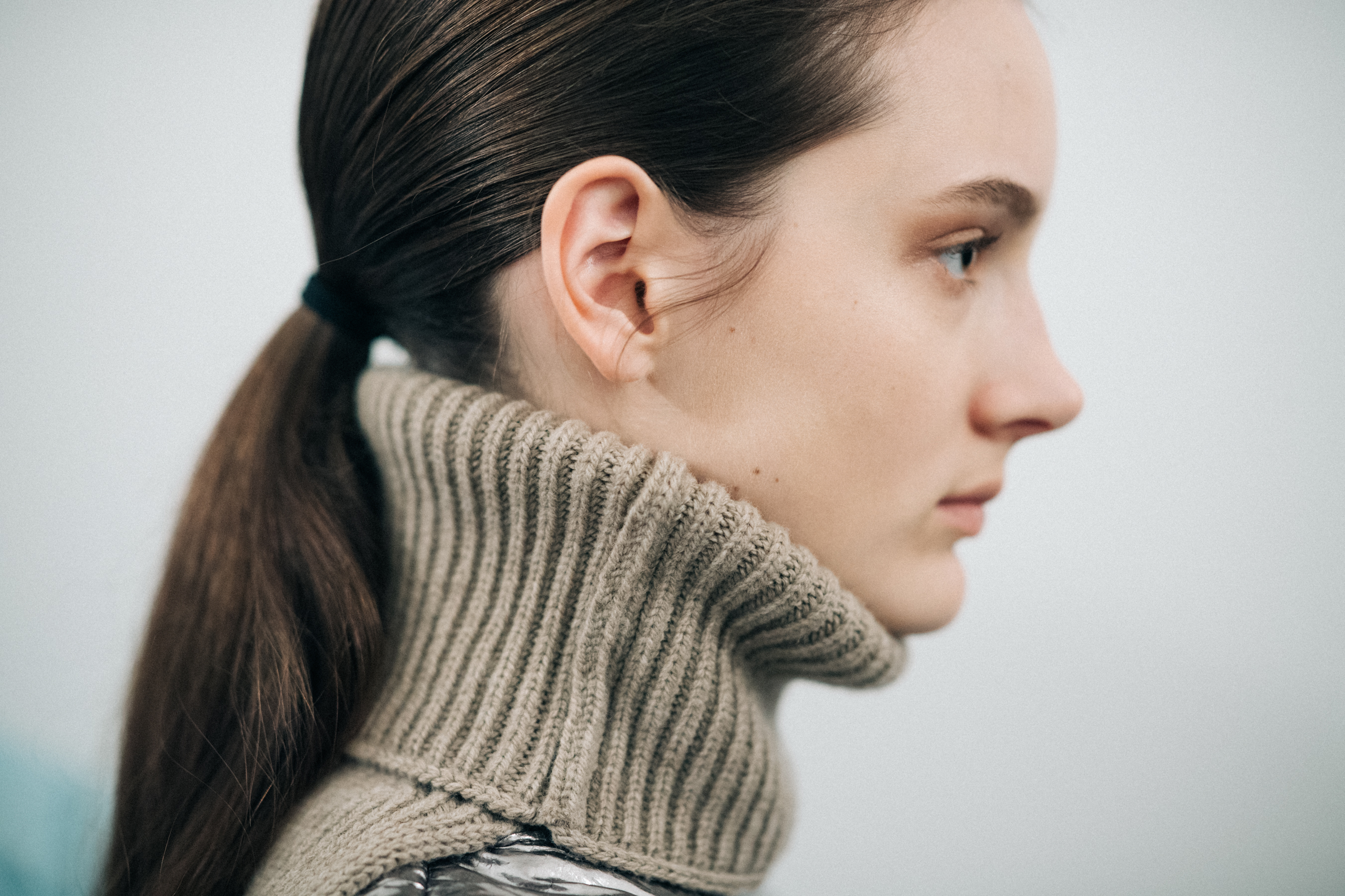 Profile of a model wearing a turtleneck