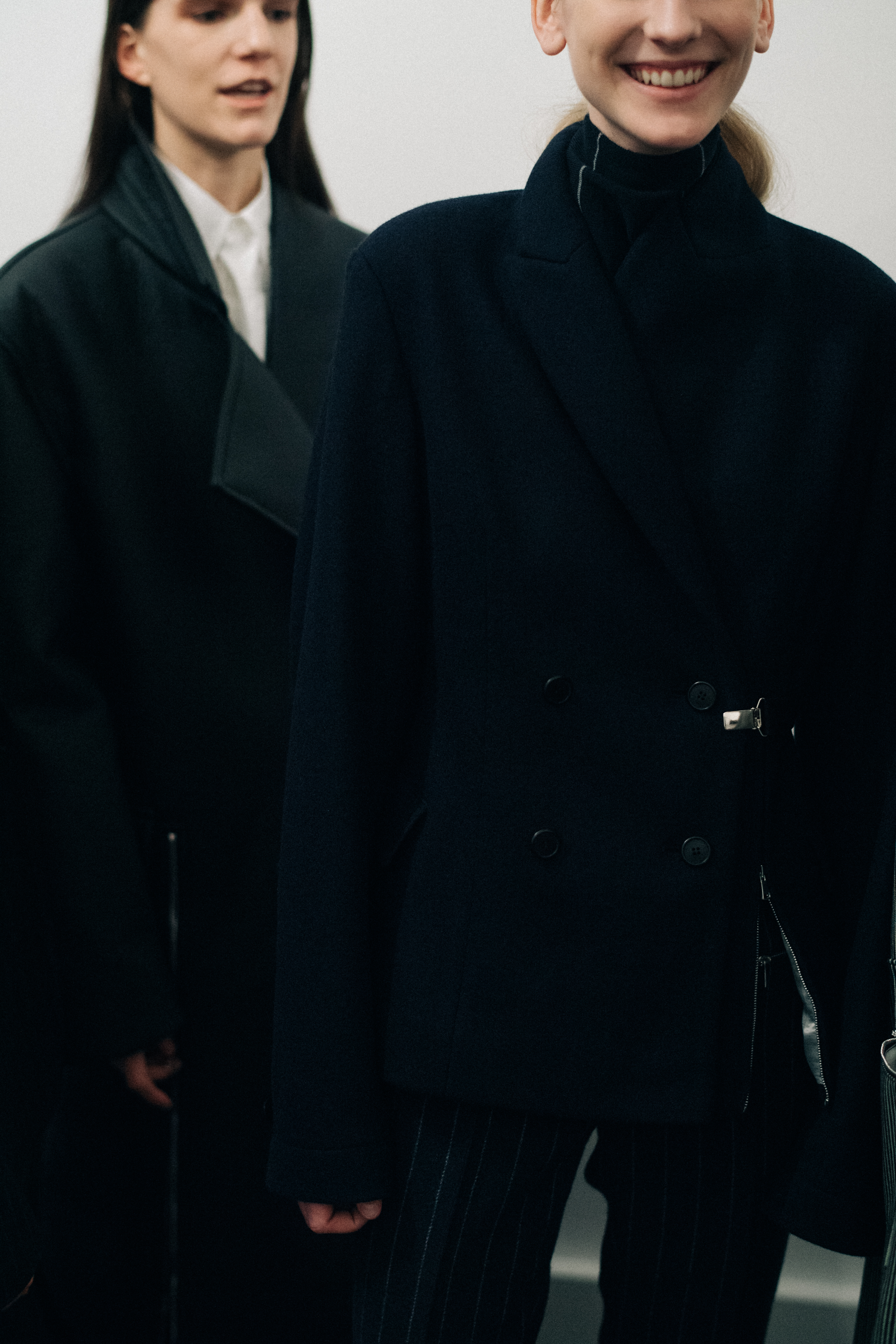 Two models wearing dark Nehera looks