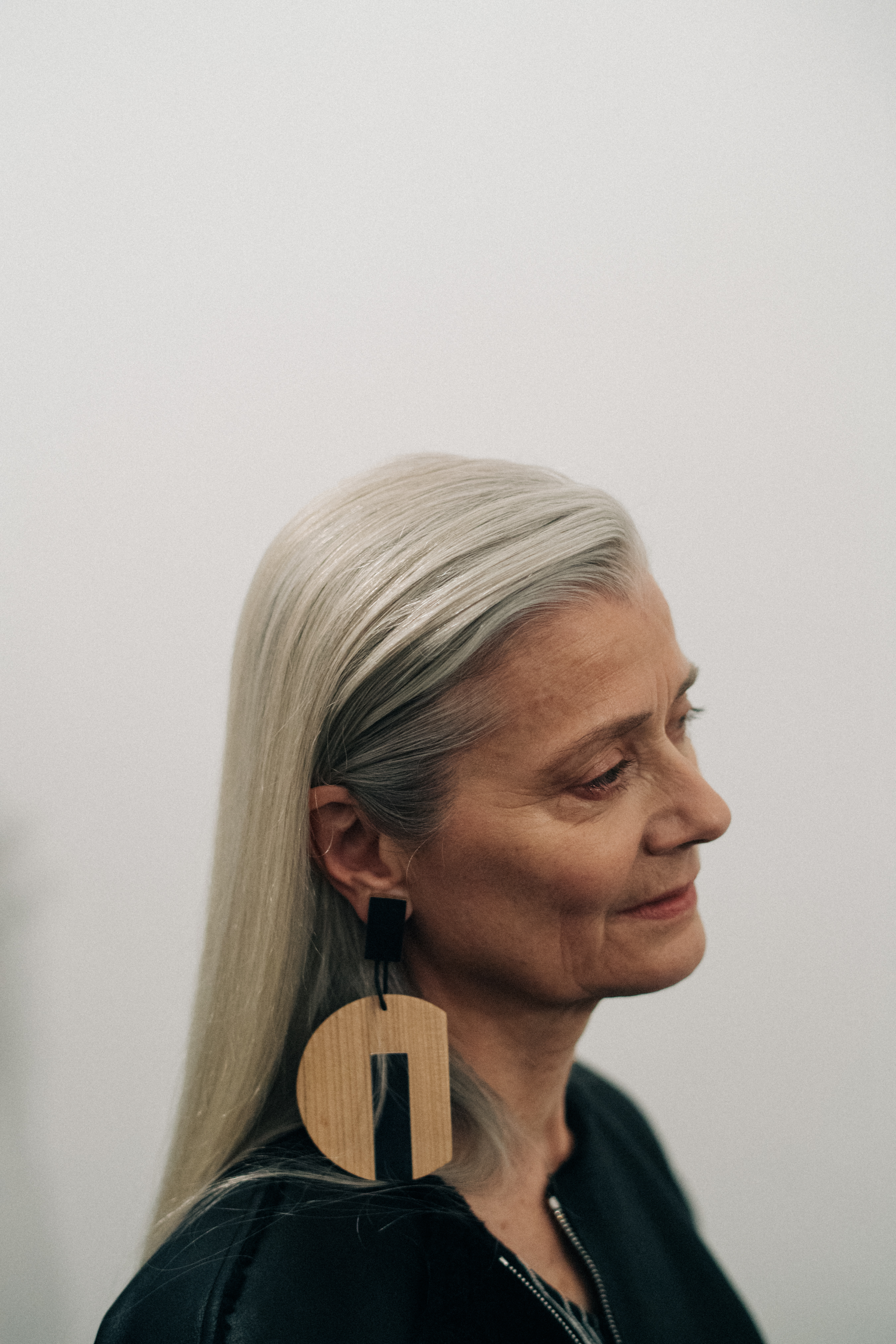 Elder model wearing a wooden earring