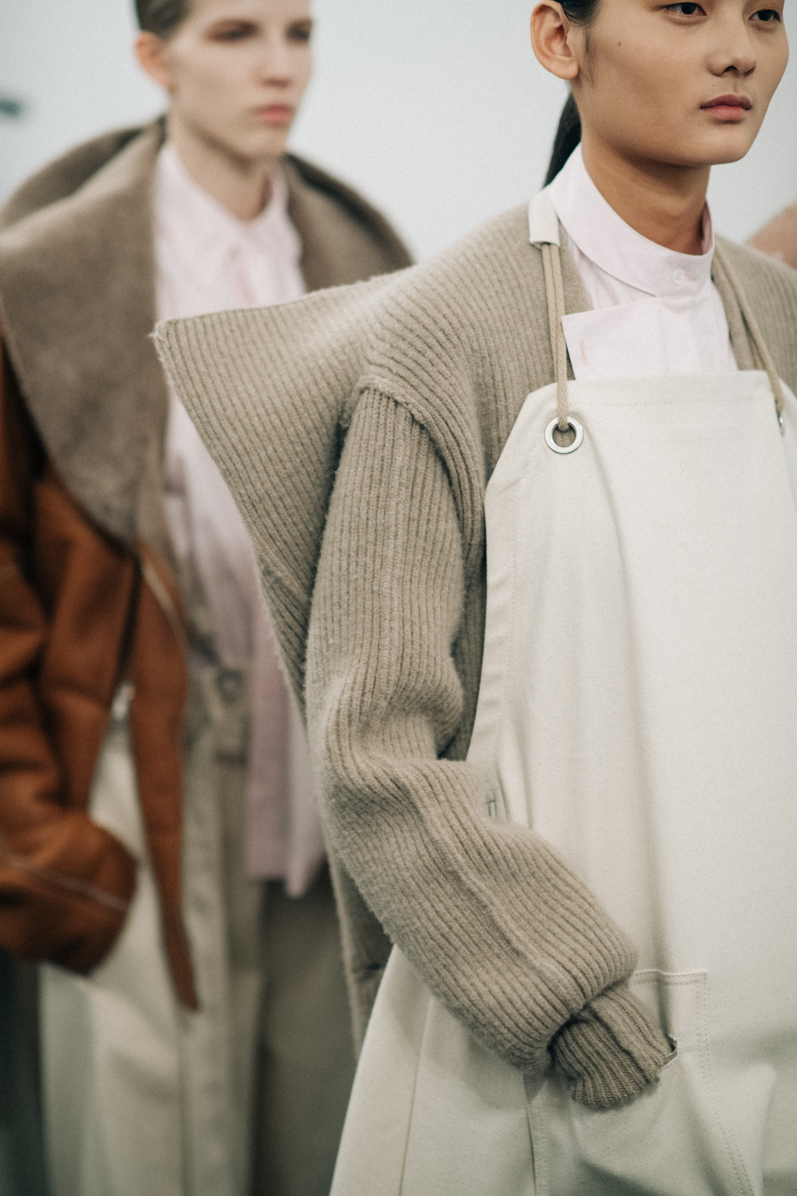 Asian model wearing a white apron