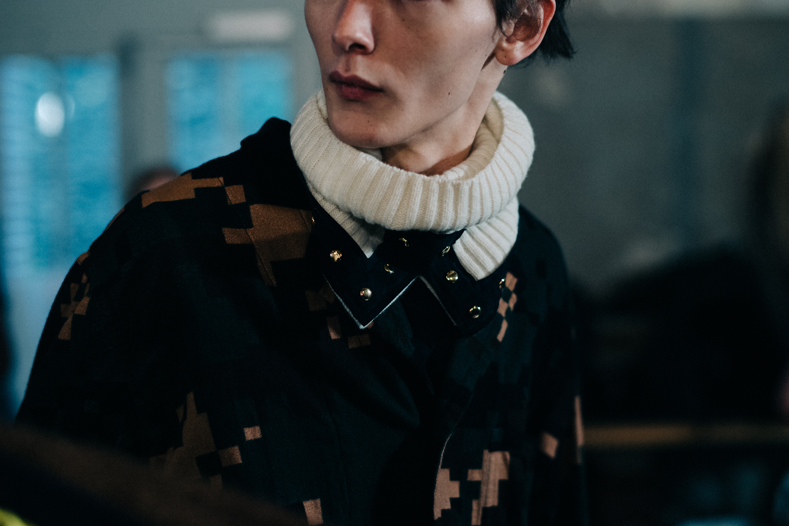 Model wearing a white turtleneck