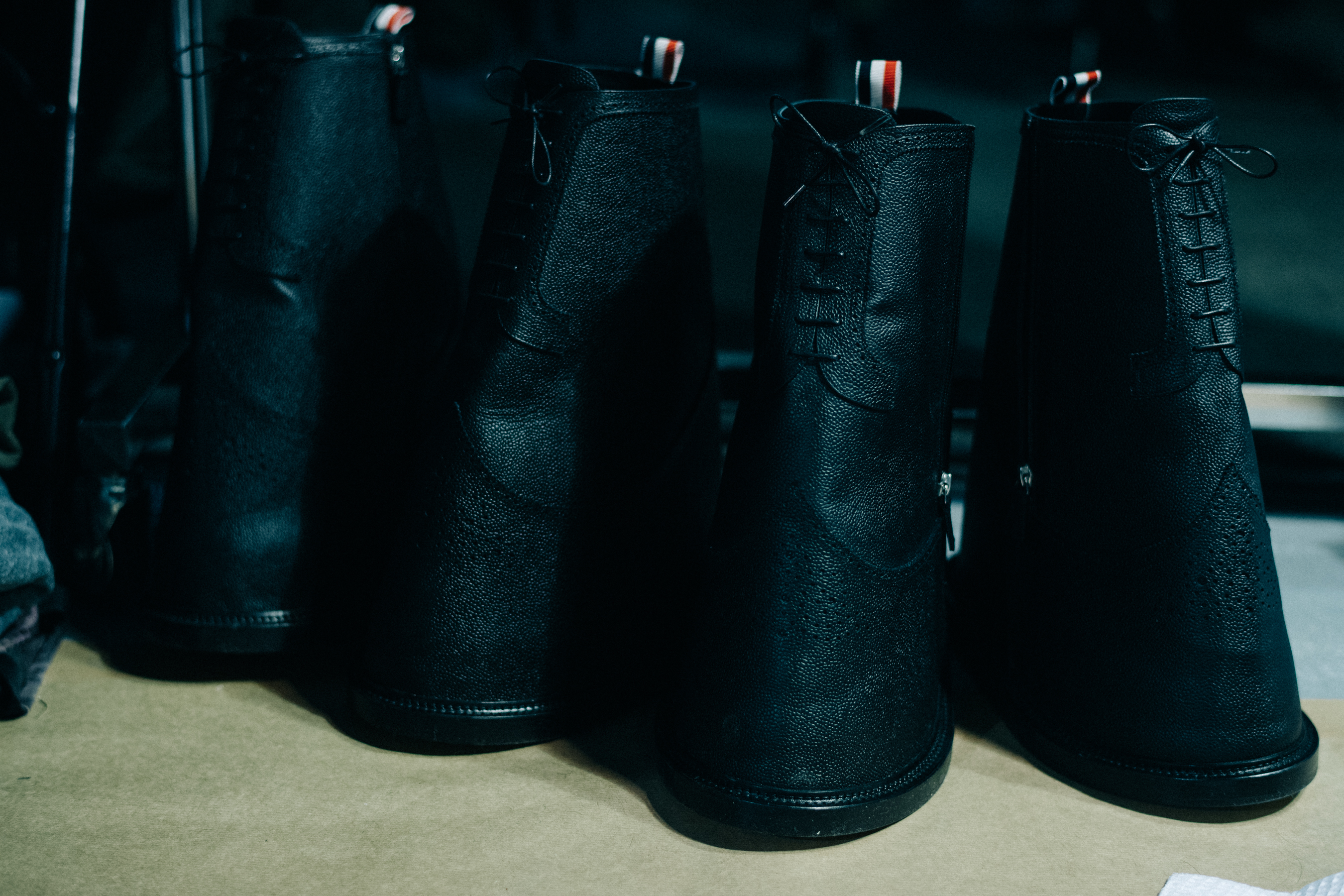 Several black Thom Browne shoes