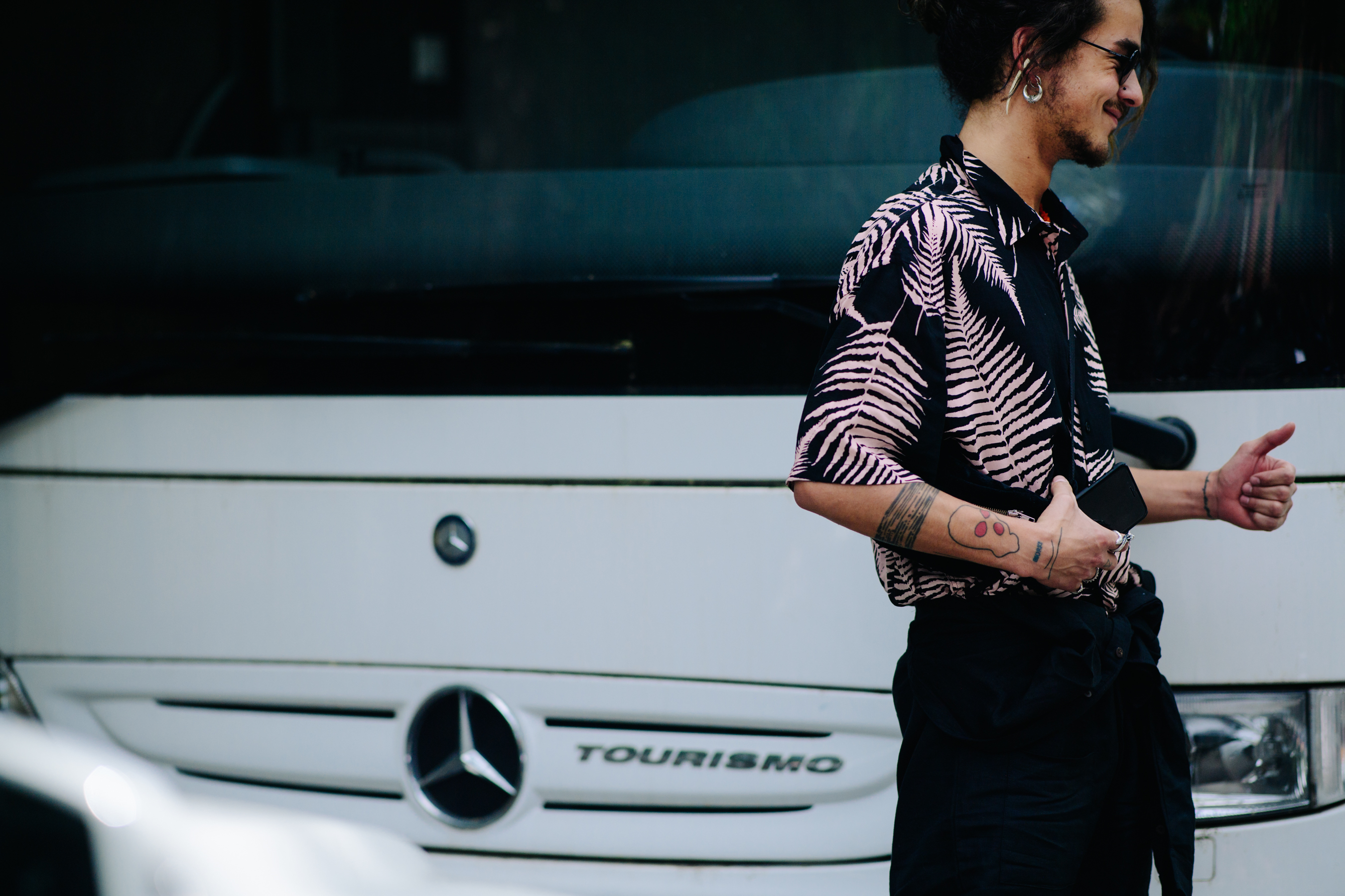 Tattooed boy wearing a print shirt