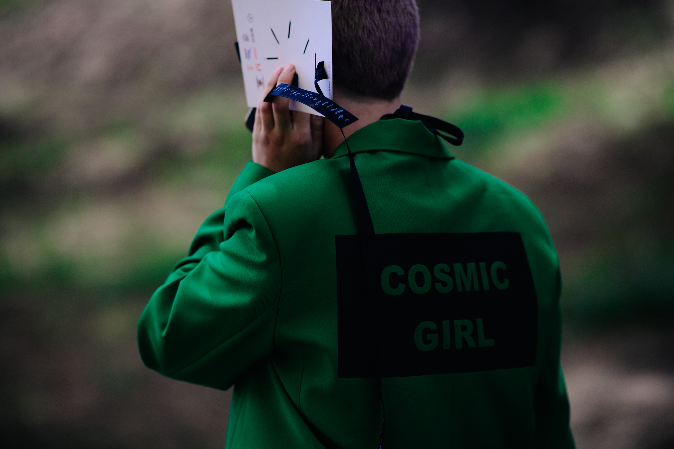 Woman wearing a printed green jacket